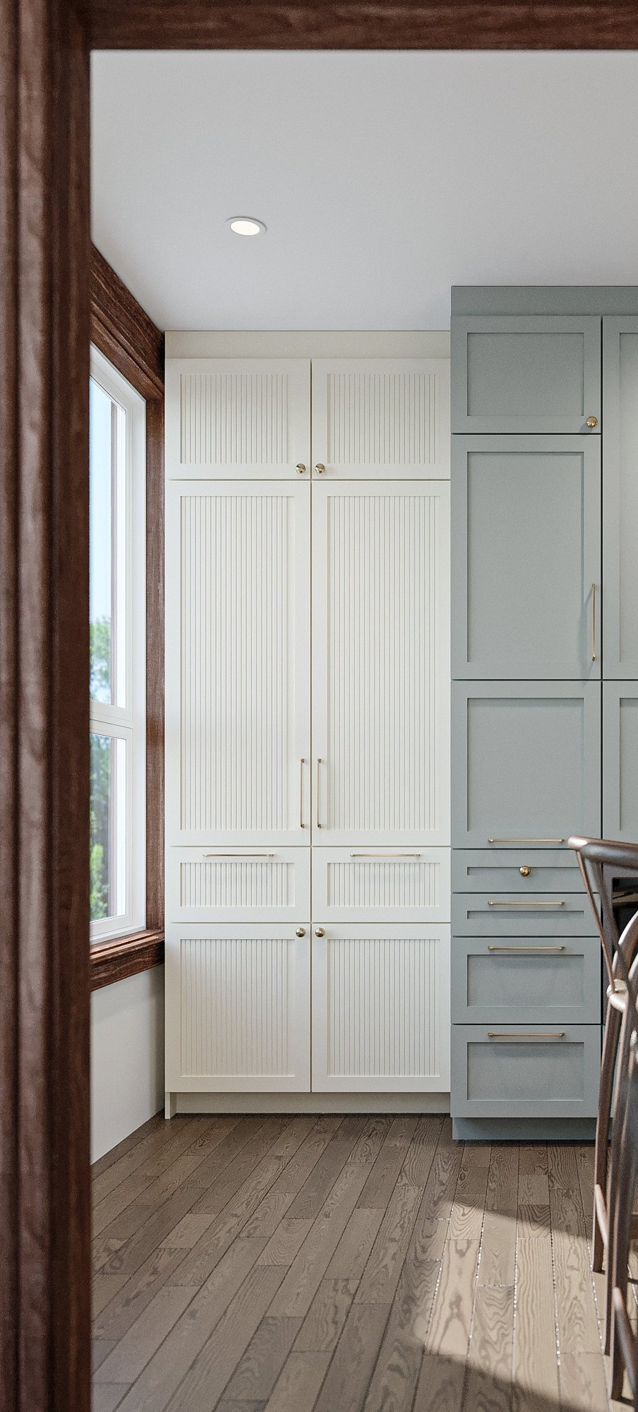 White and sage green two-tone pantry cabinetry with wood-trimmed window, farmhouse kitchen in NDG Montreal