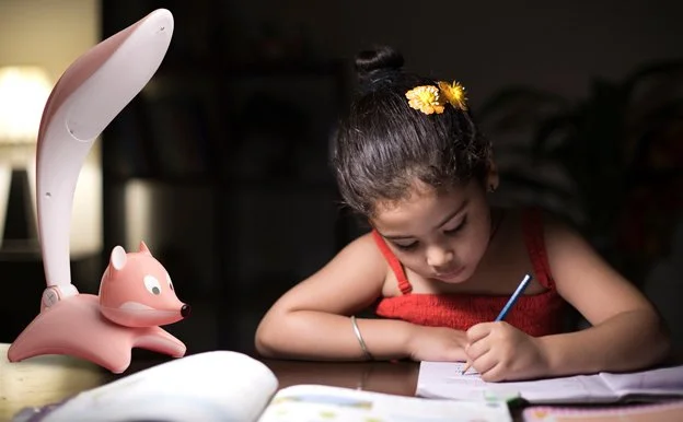 Young girl studying under pink Barmika fox LED kids desk lamp – cute and decorative light for reading and homework.