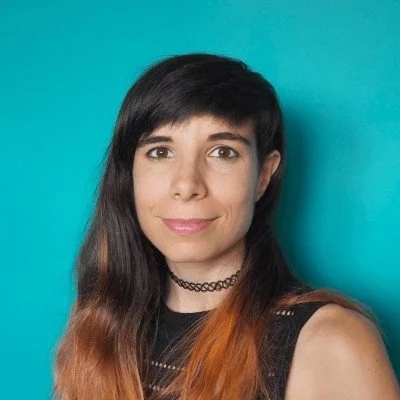 Picture of professional translator, Marina Torruella Bonsoms, against a bright blue background.
