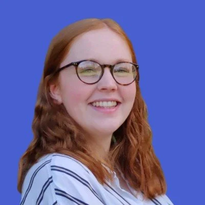 Picture of professional translator, Becca Webley, against a blue background.