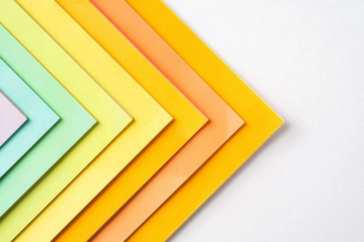 colored pieces of paper in a stack, offset and aligned