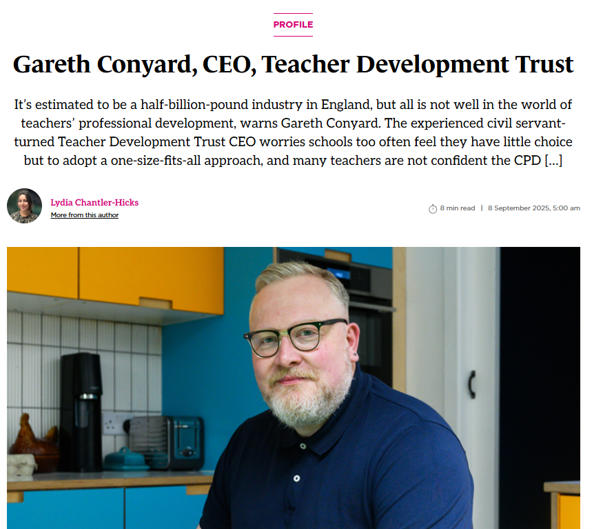Gareth Conyard, CEO of Teacher Development Trust, with a beard, glasses, and a navy polo, seated in a colorful kitchen.