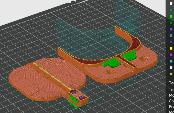 3D model of a headphone with the headband and ear cups separated, displayed on a grid with color-coded measurement and analysis tools.