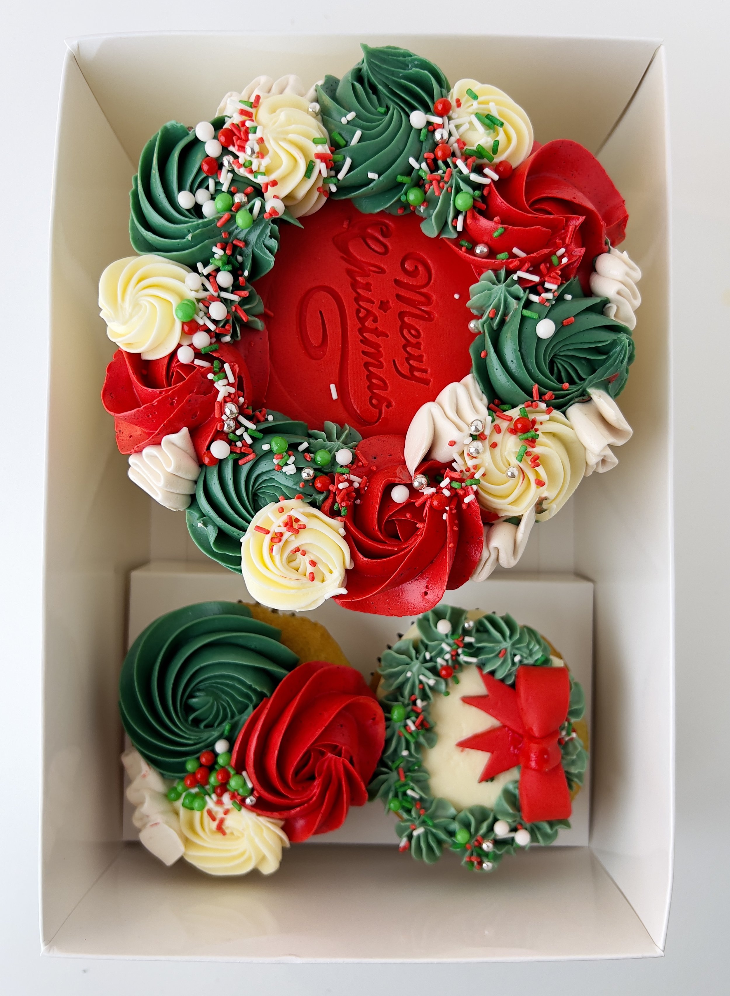 Christmas-Themed Bento Cake and Cupcakes by Sensational Cakes and Desserts Perfect for holiday parties, family gatherings, or as a sweet gift for Christmas Celebrations.