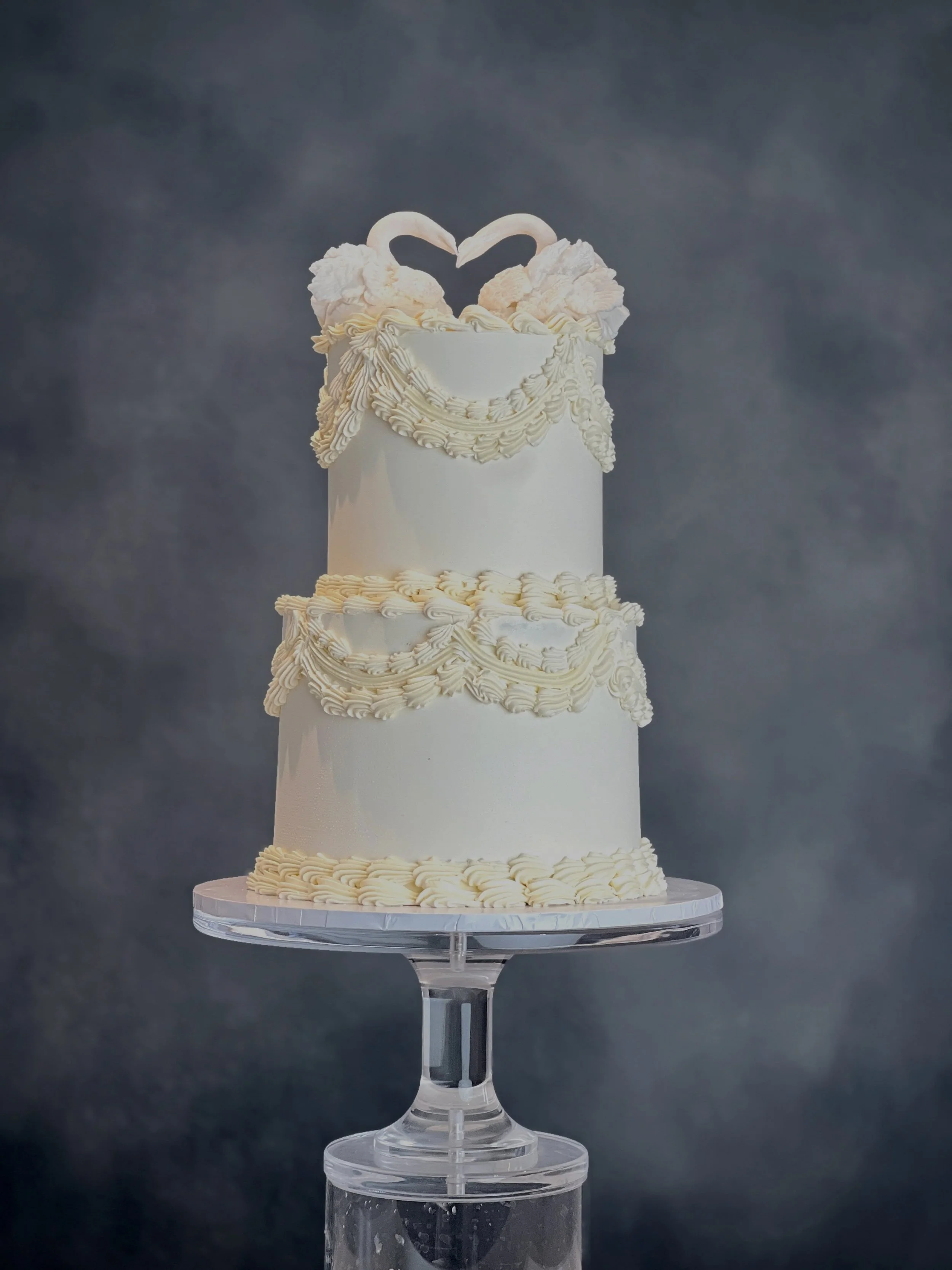 Two swans, one beautiful love story🦢

A timeless all-white wedding cake featuring handcrafted swans, intricate vintage piping and delicate details throughout.

The swans coming together to form a heart made this design even more special and hearing 