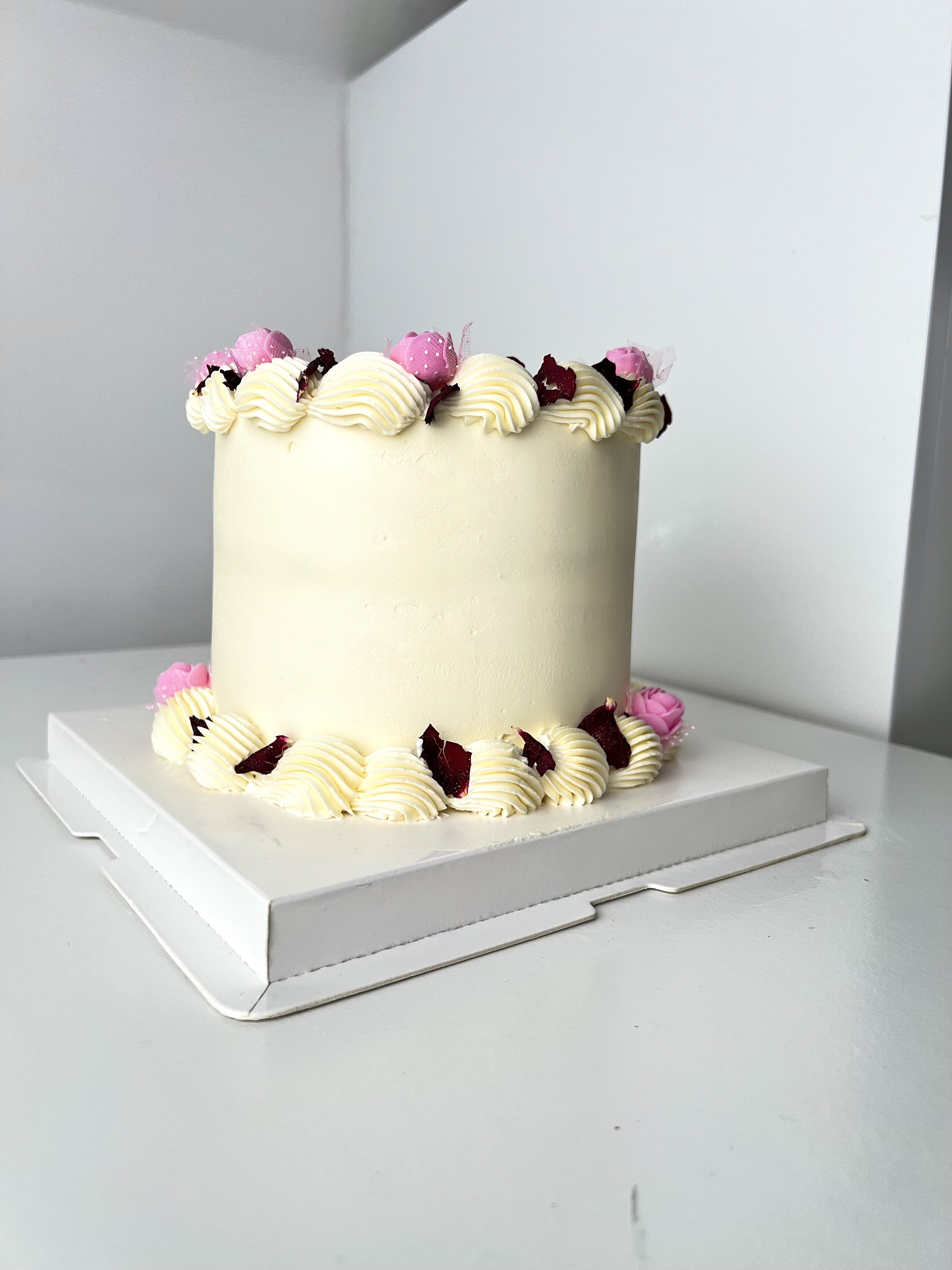 Side view of the Mini Cake With Edible Pink Floral Petals by Sensational Cakes and Desserts
