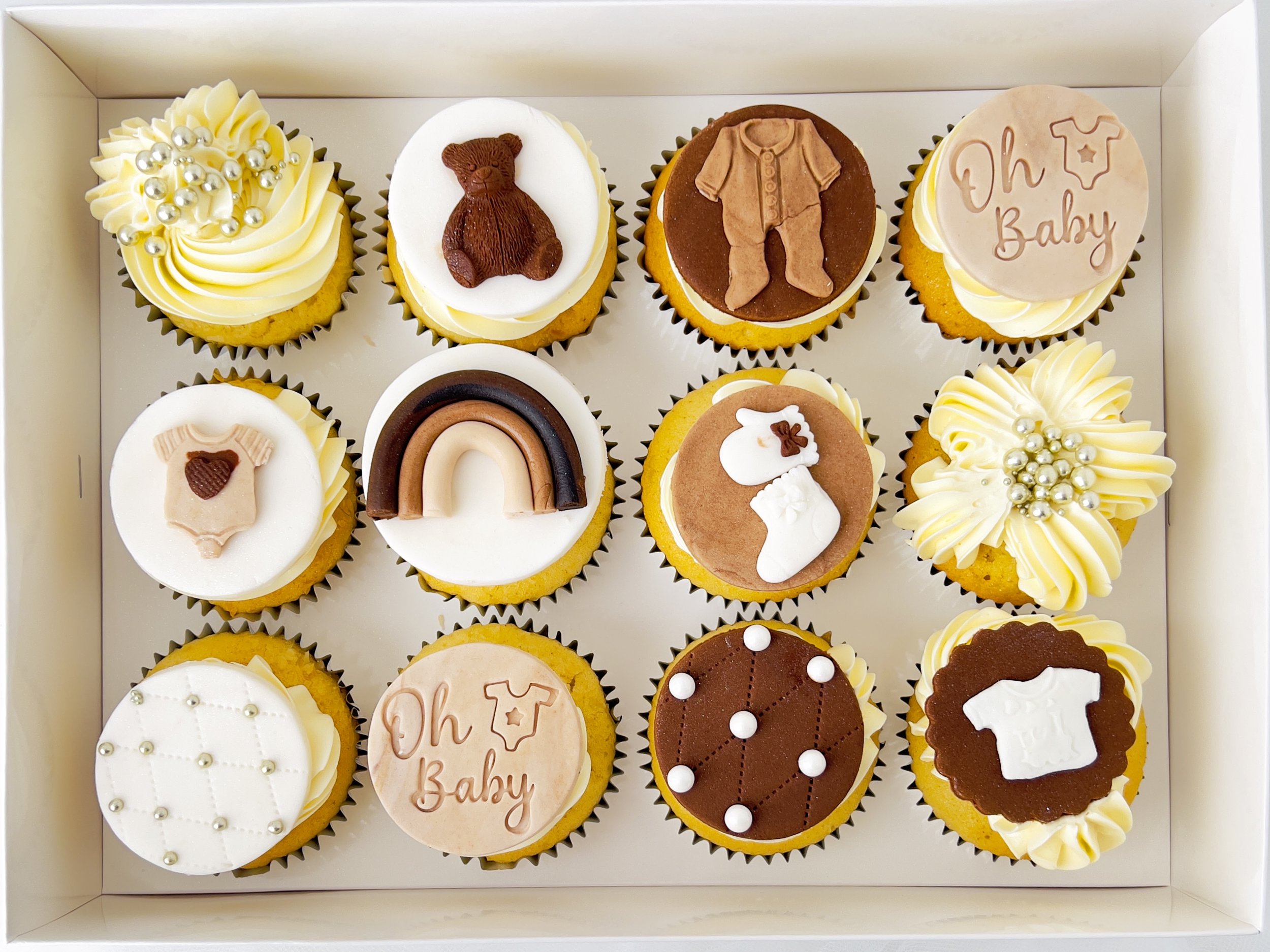Neutral Baby Shower Cupcakes by Sensational Cakes and Desserts. Each Cupcake is Adorned with Edible Neutral Baby Shower Fondant Sugar Cake Cupcake Decorations Toppers.