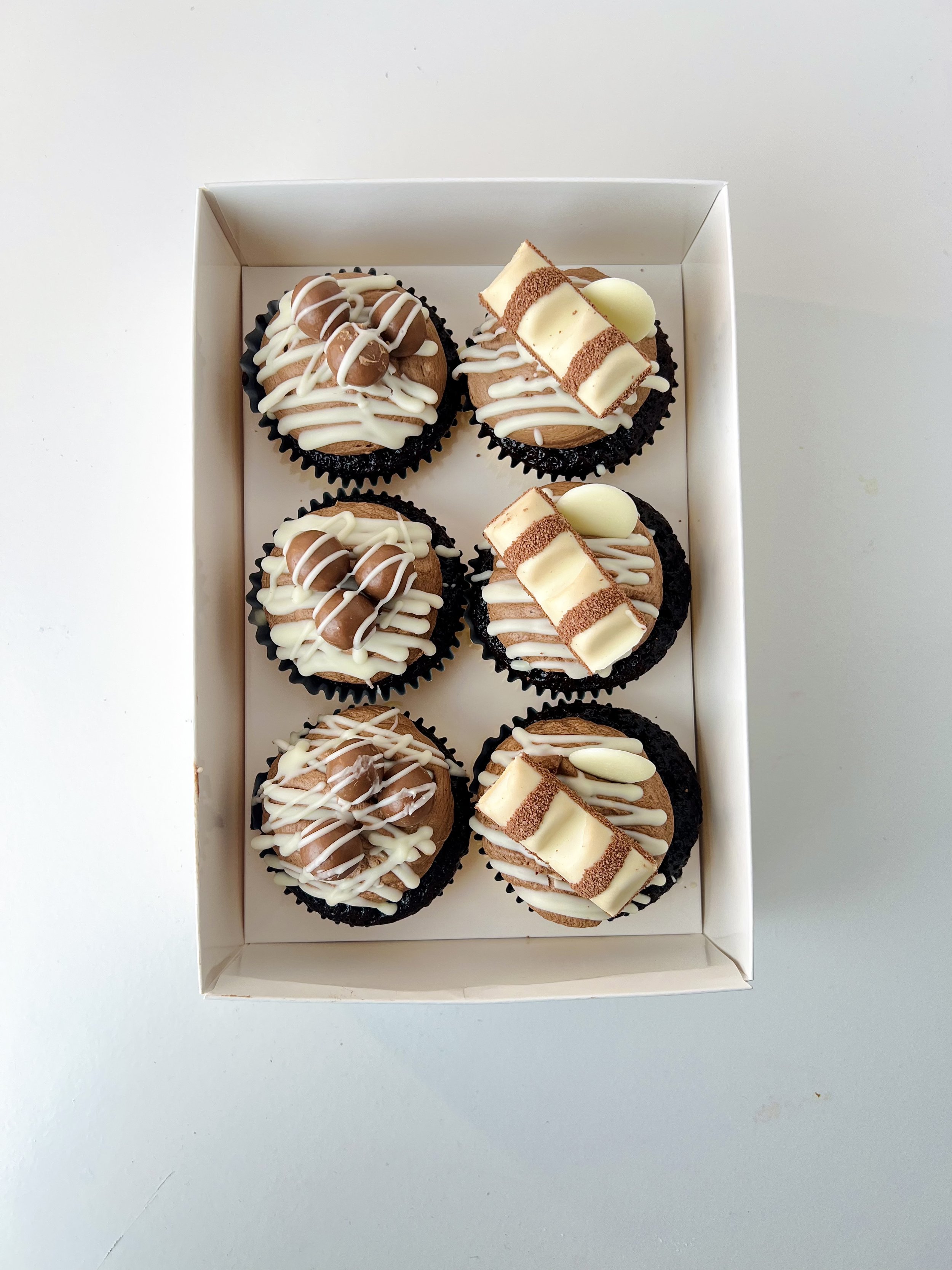 Chocolate Selection Cupcakes (Box of 6) by Sensational Cakes and Desserts topped with chocolate buttercream, Maltesers or Kinder Bueno