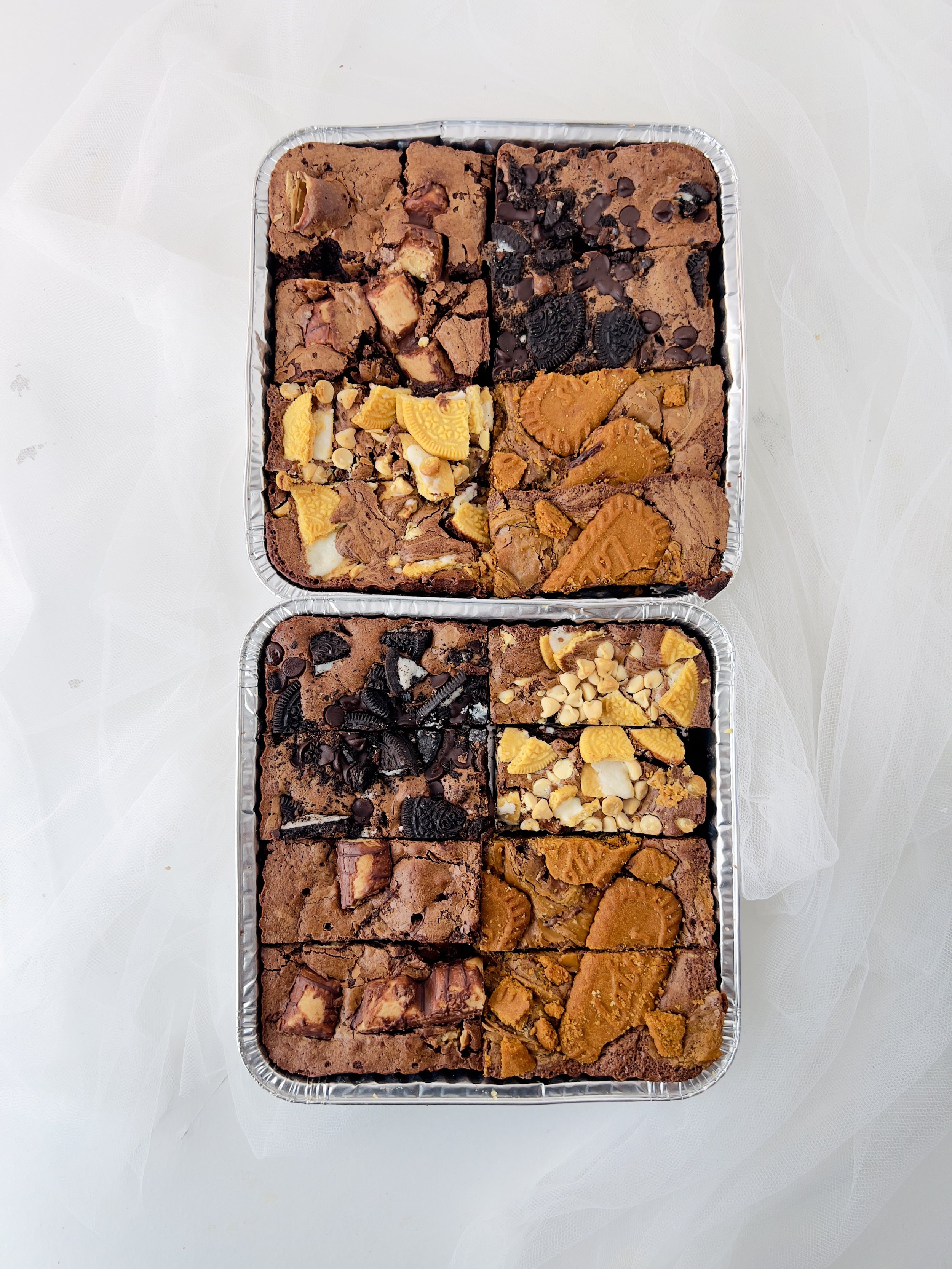 Brownie Selection Tray by Sensational Cakes and Desserts featuring Kinder Bueno Brownies, Oreo and Dark Chocolate Brownies, Golden Oreo with White Chocolate Brownies, and Lotus Biscoff Brownies.