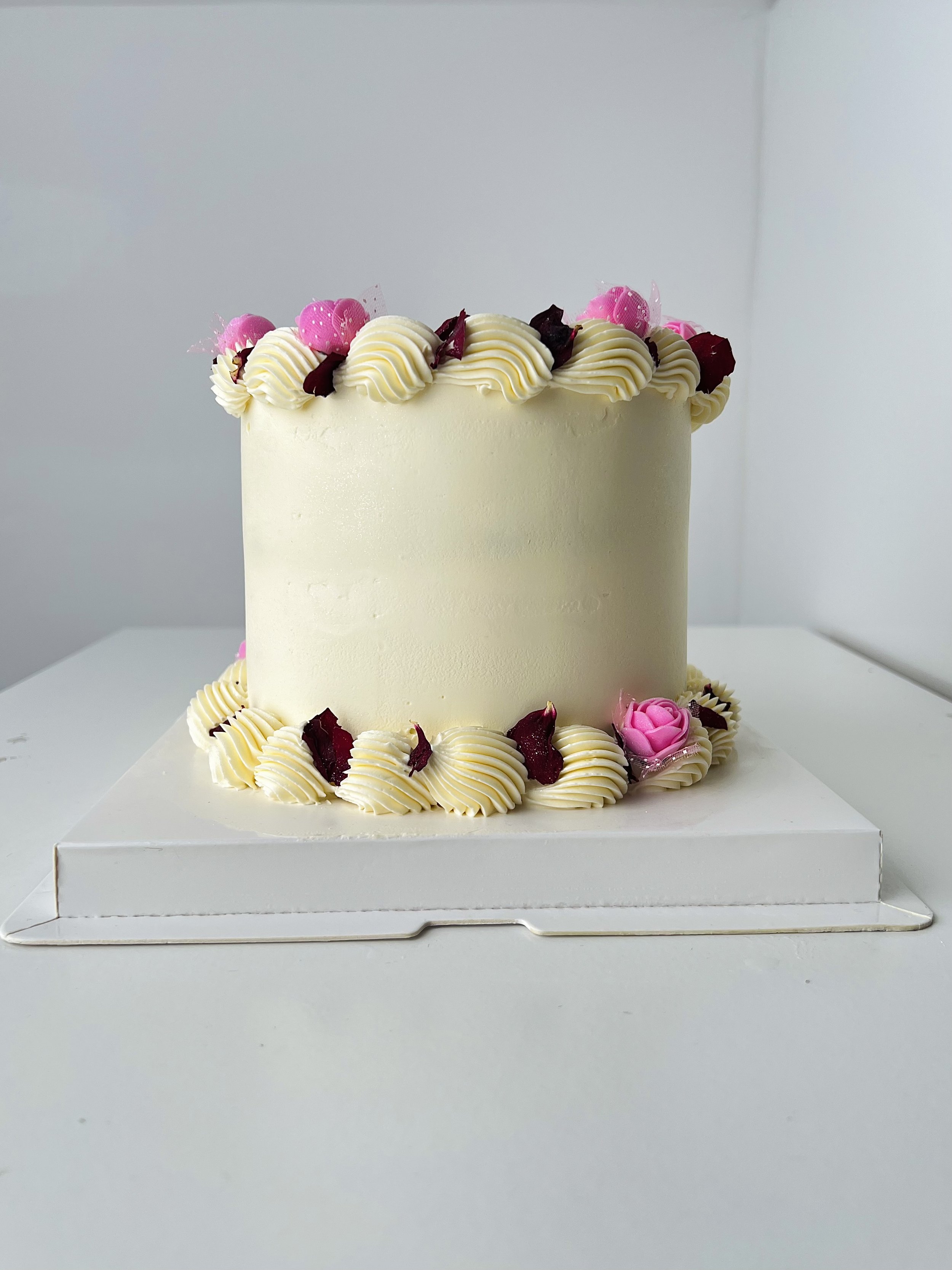 Side view of the Mini Cake With Edible Pink Floral Petals by Sensational Cakes and Desserts