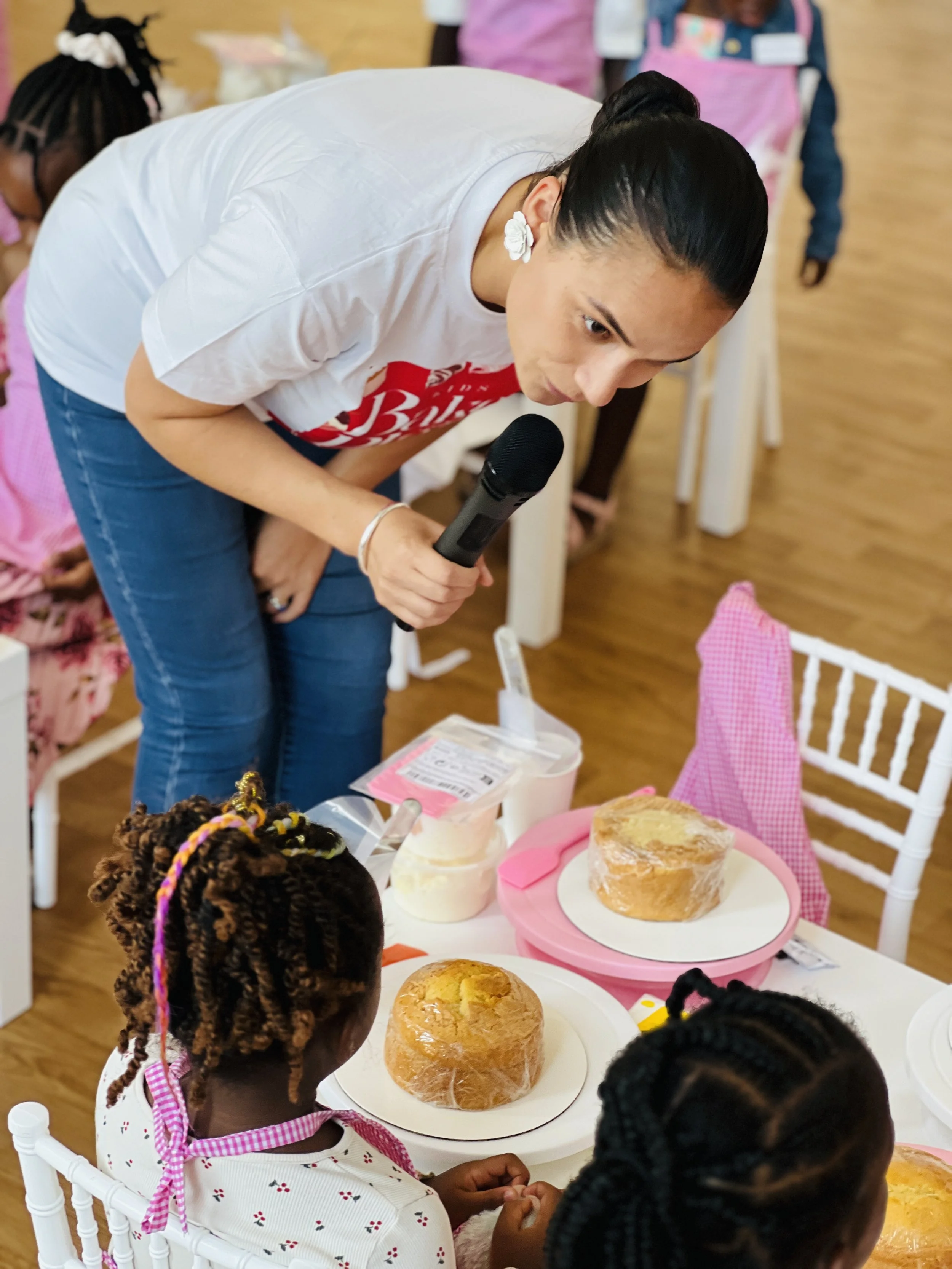 Kids Bake & Play with Sensational Cakes and Desserts team member speaking with a kid