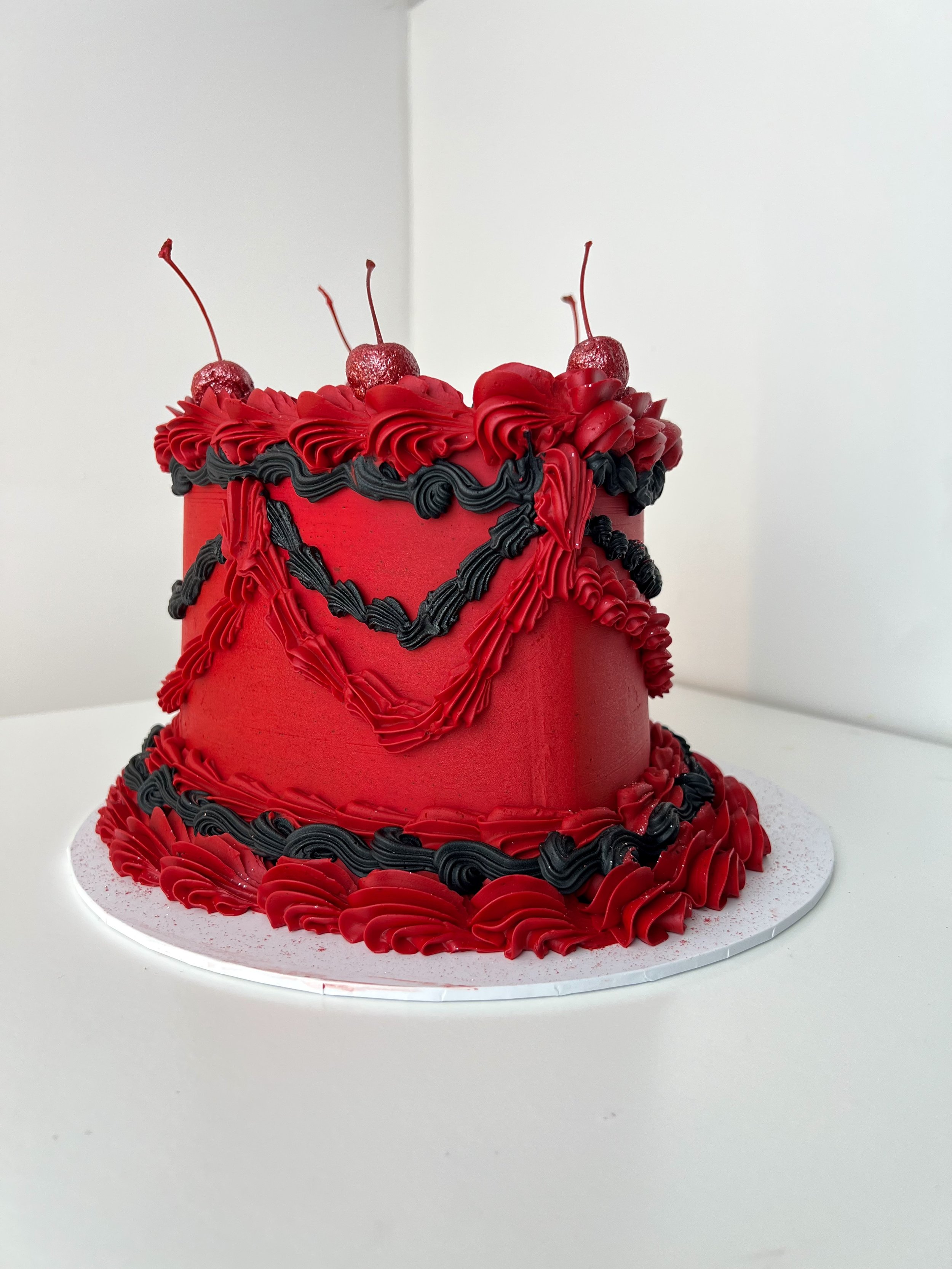 Left side view of the Red and Black Vintage Heart Cake by Sensational Cakes and Desserts.