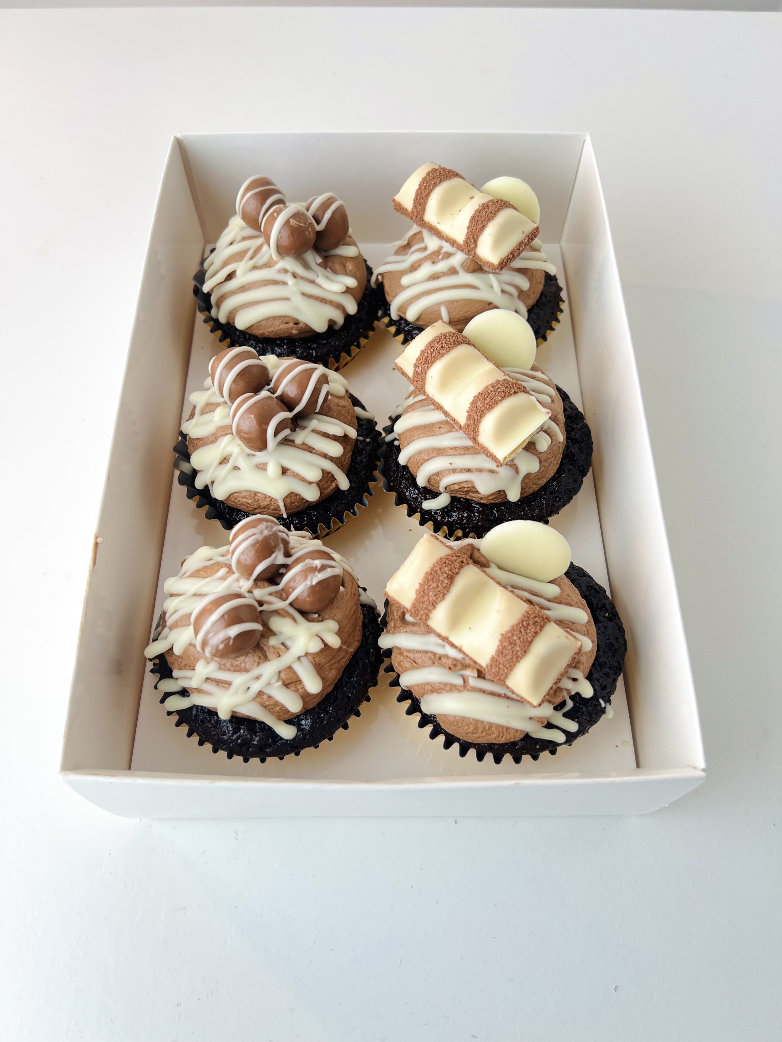 Chocolate Selection Cupcakes (Box of 6) by Sensational Cakes and Desserts topped with chocolate buttercream, Maltesers or Kinder Bueno