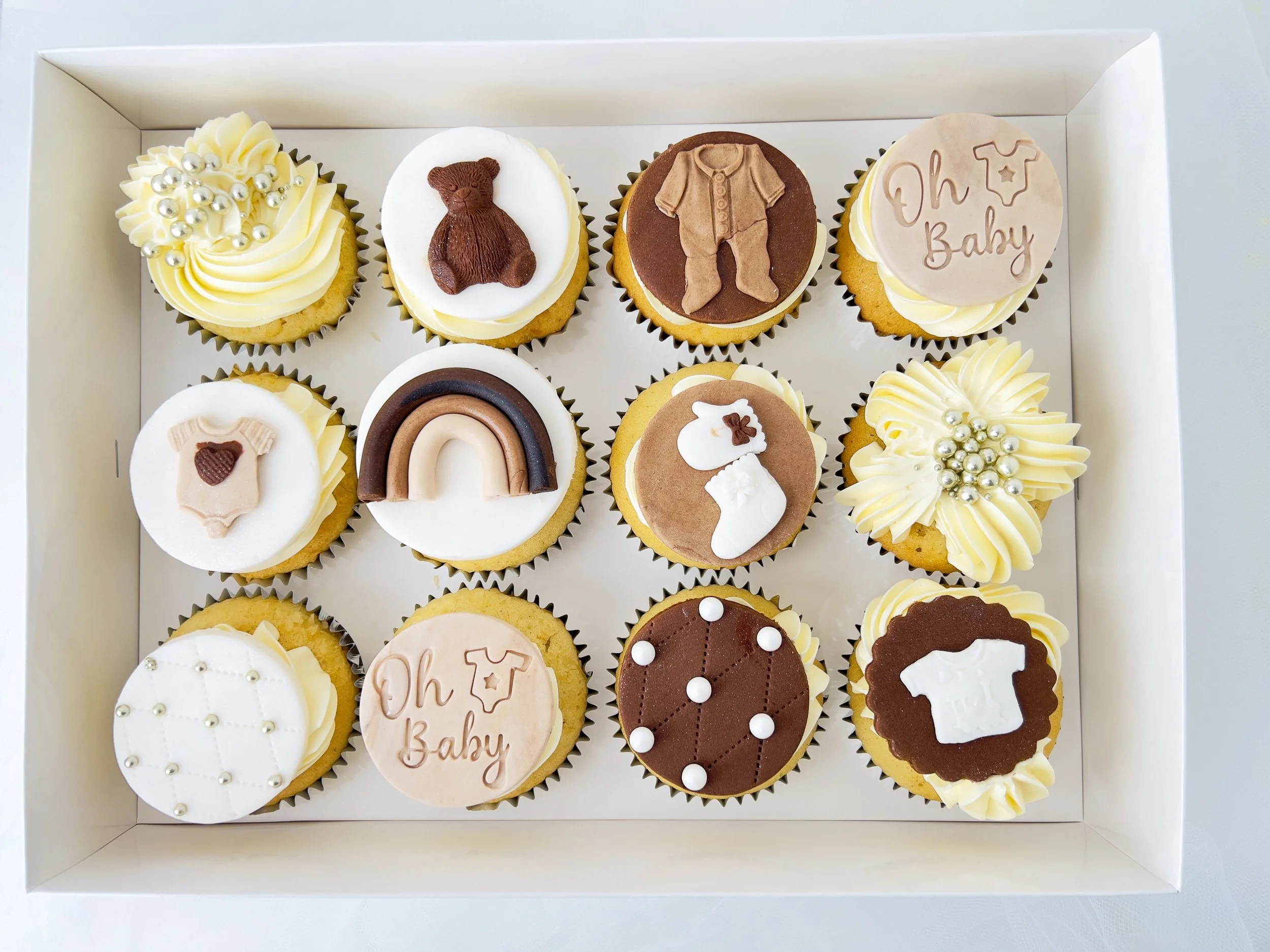 Neutral Baby Shower Cupcakes by Sensational Cakes and Desserts. Each Cupcake is Adorned with Edible Neutral Baby Shower Fondant Sugar Cake Cupcake Decorations Toppers.