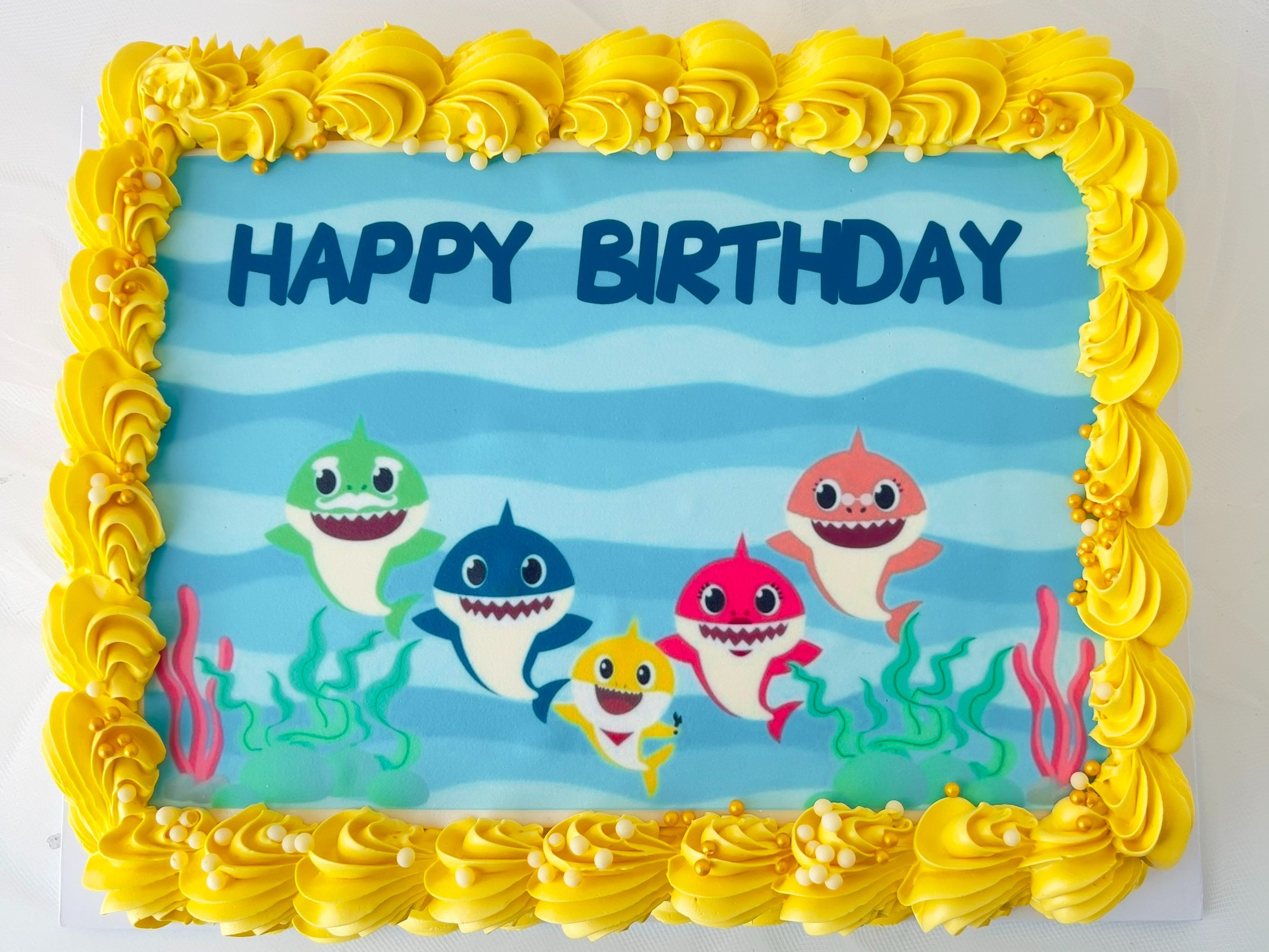 Baby Shark Character Sheet Cake (Customisable) by Sensational Cakes and Desserts with Yellow Delicately Piped Buttercream.