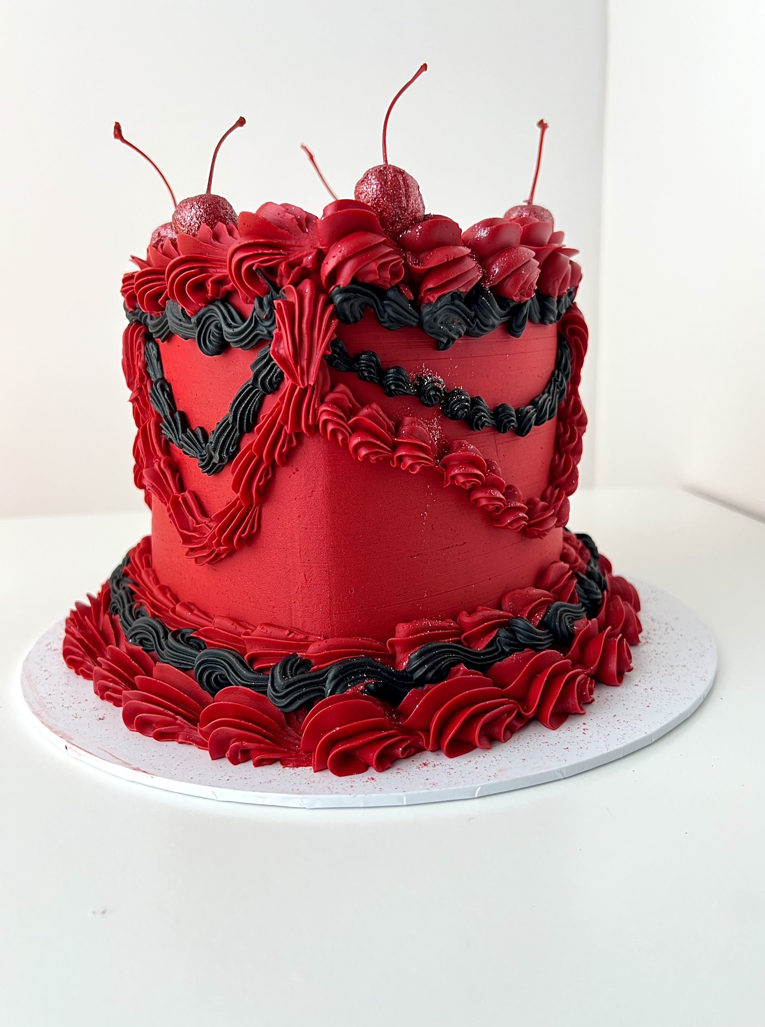 front side view of the Red and Black Vintage Heart Cake by Sensational Cakes and Desserts.