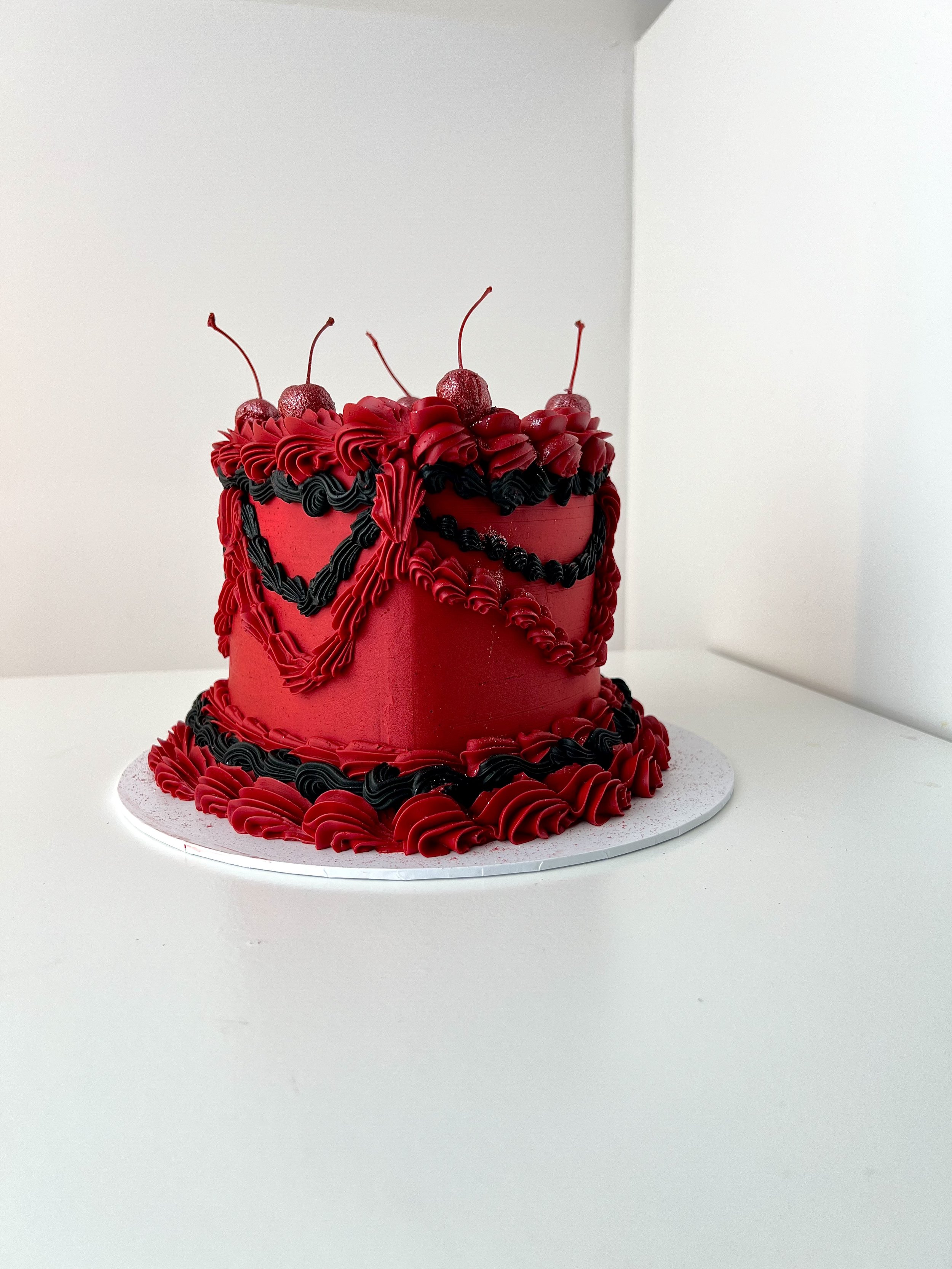 Front side view of the Red and Black Vintage Heart Cake by Sensational Cakes and Desserts.
