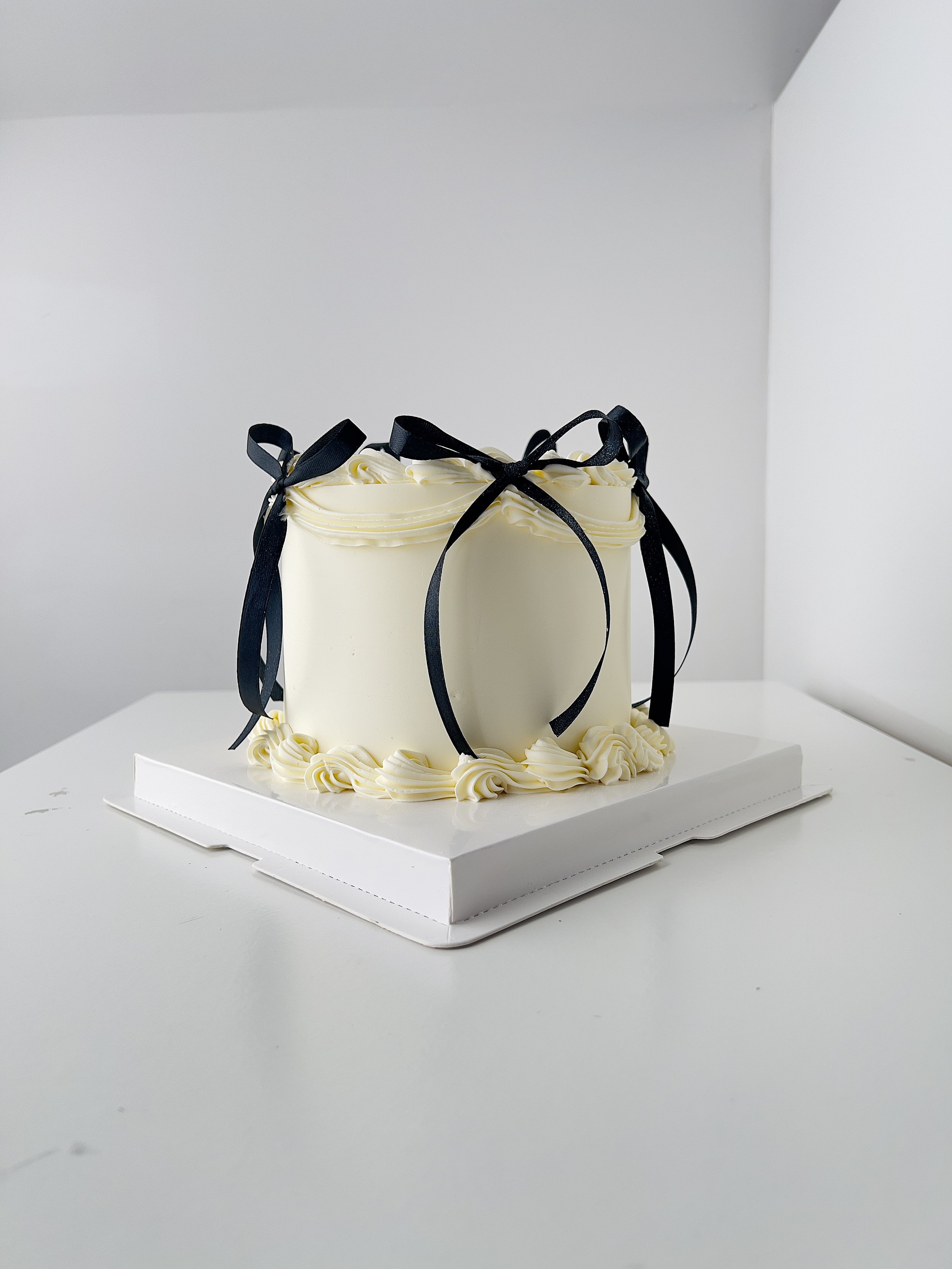 Side view of the Mini Calendar Birthday Cake with Black Ribbon by Sensational Cakes and Desserts