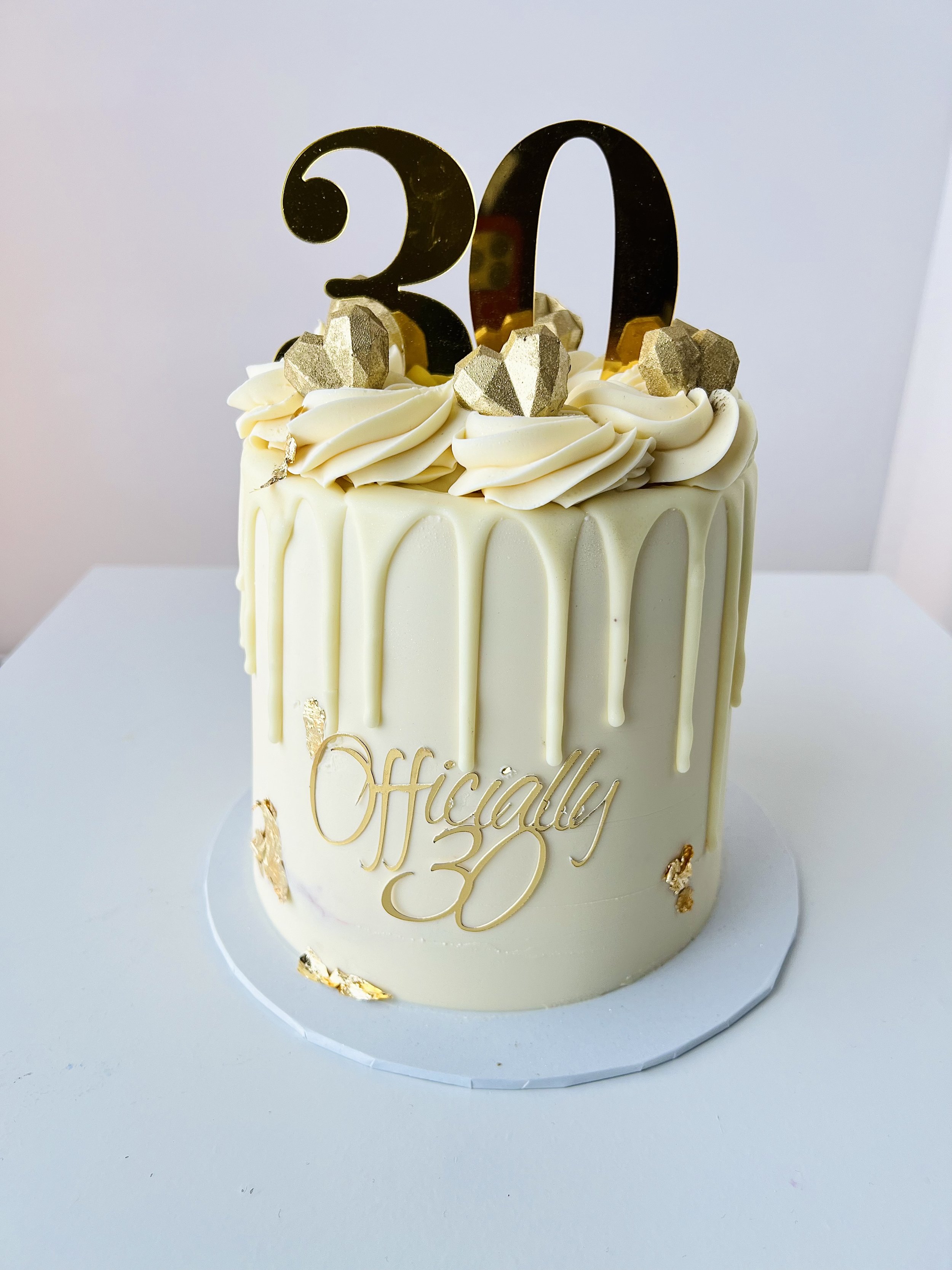 White Dripped Cake with Gold Number Topper by Sensational Cakes and Desserts