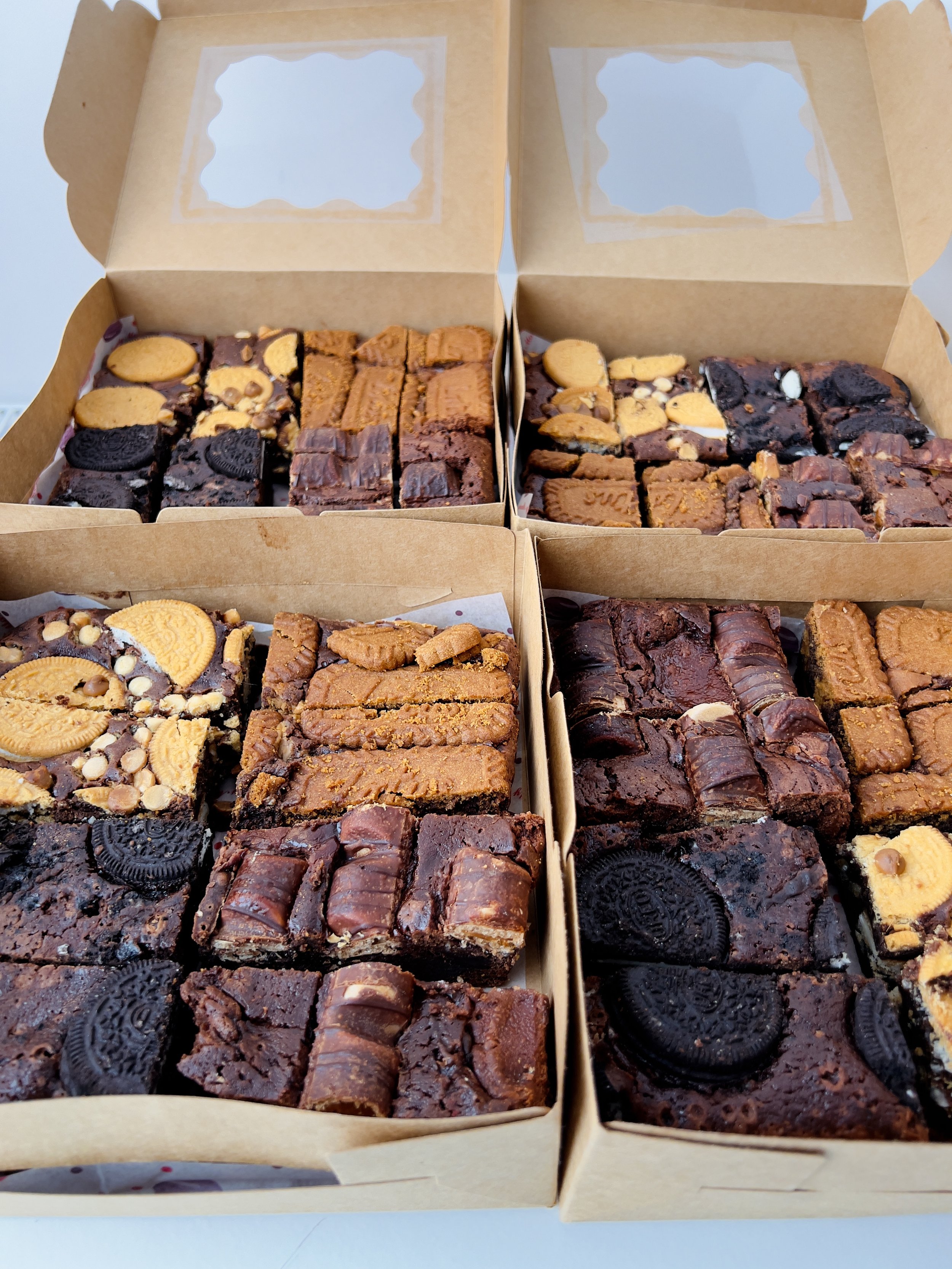 Brownie Selection Tray by Sensational Cakes and Desserts featuring Kinder Bueno Brownies, Oreo and Dark Chocolate Brownies, Golden Oreo with White Chocolate Brownies, and Lotus Biscoff Brownies.