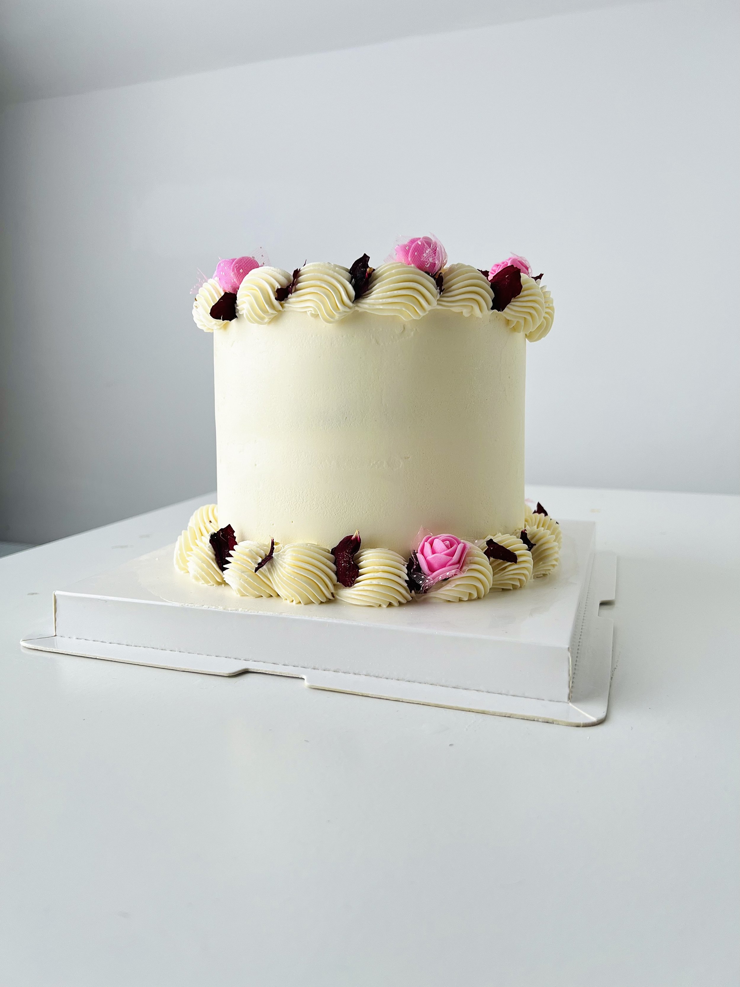 Side view of the Mini Cake With Edible Pink Floral Petals by Sensational Cakes and Desserts