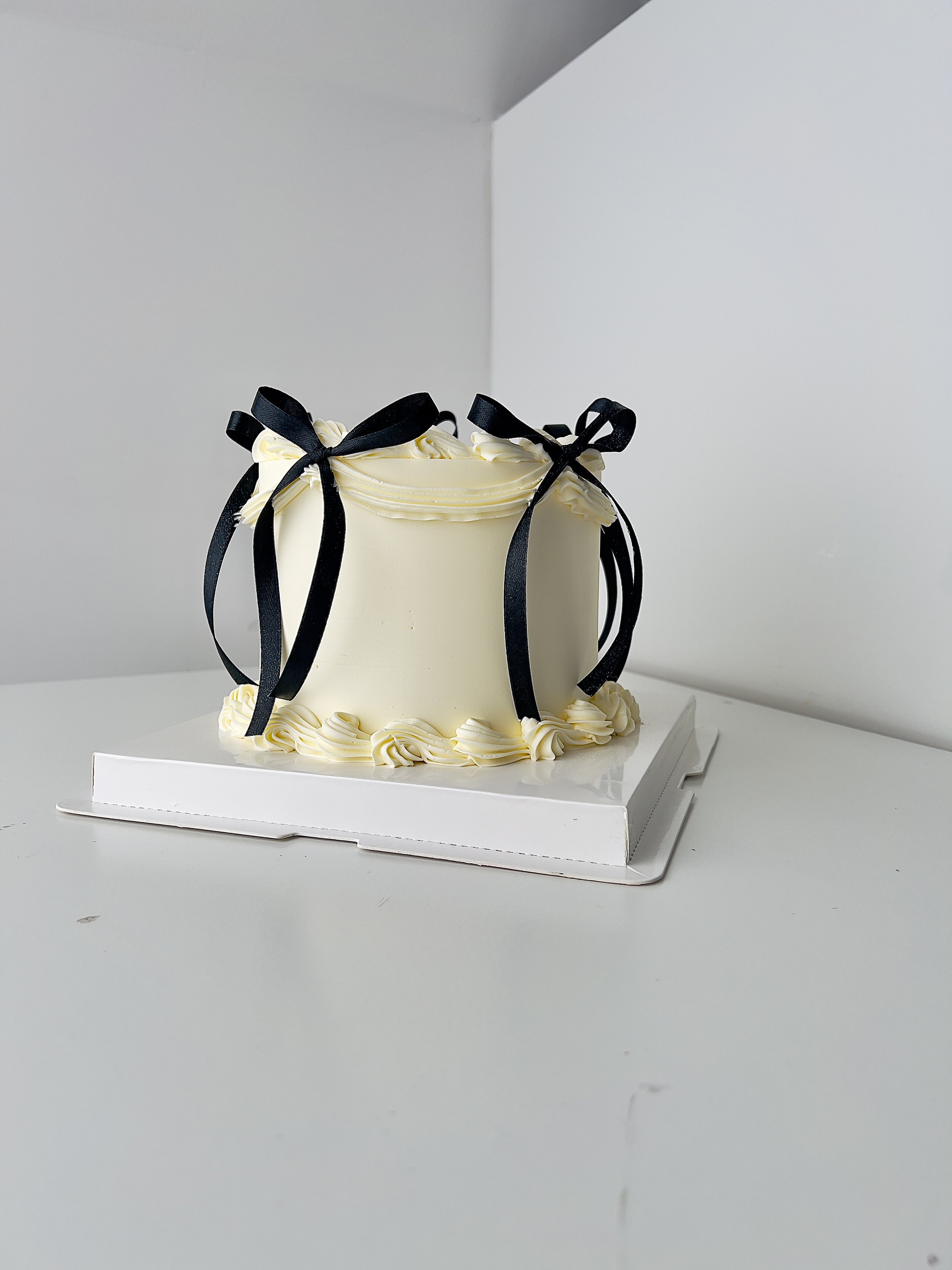 Side view of the Mini Calendar Birthday Cake with Black Ribbon by Sensational Cakes and Desserts