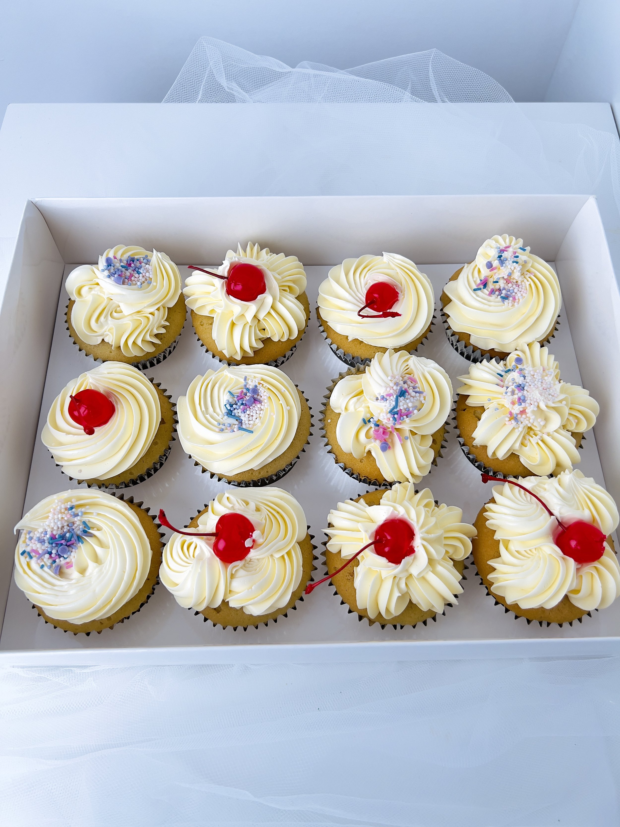 Sprinkles and Glazed Cherry Topped Cupcakes (Box of 12) by Sensational Cakes and Desserts.