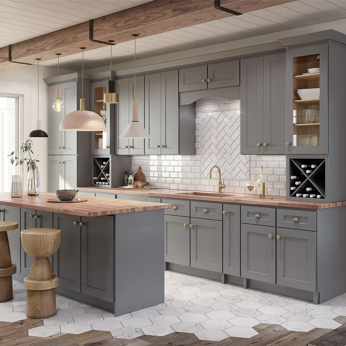 A modern kitchen with gray cabinets, wooden countertops, and a white tile backsplash featuring herringbone and brick patterns. It has pendant lights hanging over a kitchen island, with decorative vases and a bowl on the island, and stools at the counter. The floor combines white hexagonal and wood tiles.