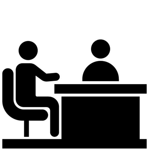 Silhouette of two people sitting at a desk, one person on each side, in an interview or meeting setting.