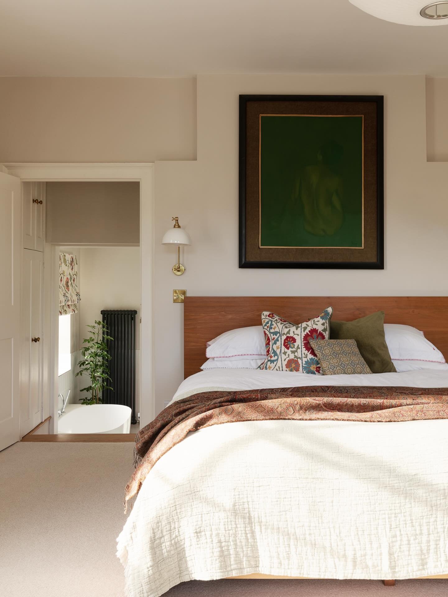 MASTER SUITE &bull; In this rural Kent master bedroom, soft colours and gentle patterns combine to make this sun filled space calm and refined. 

The wall lights from @sparkandbell provide practical space saving solution to bedside lighting. Cushions