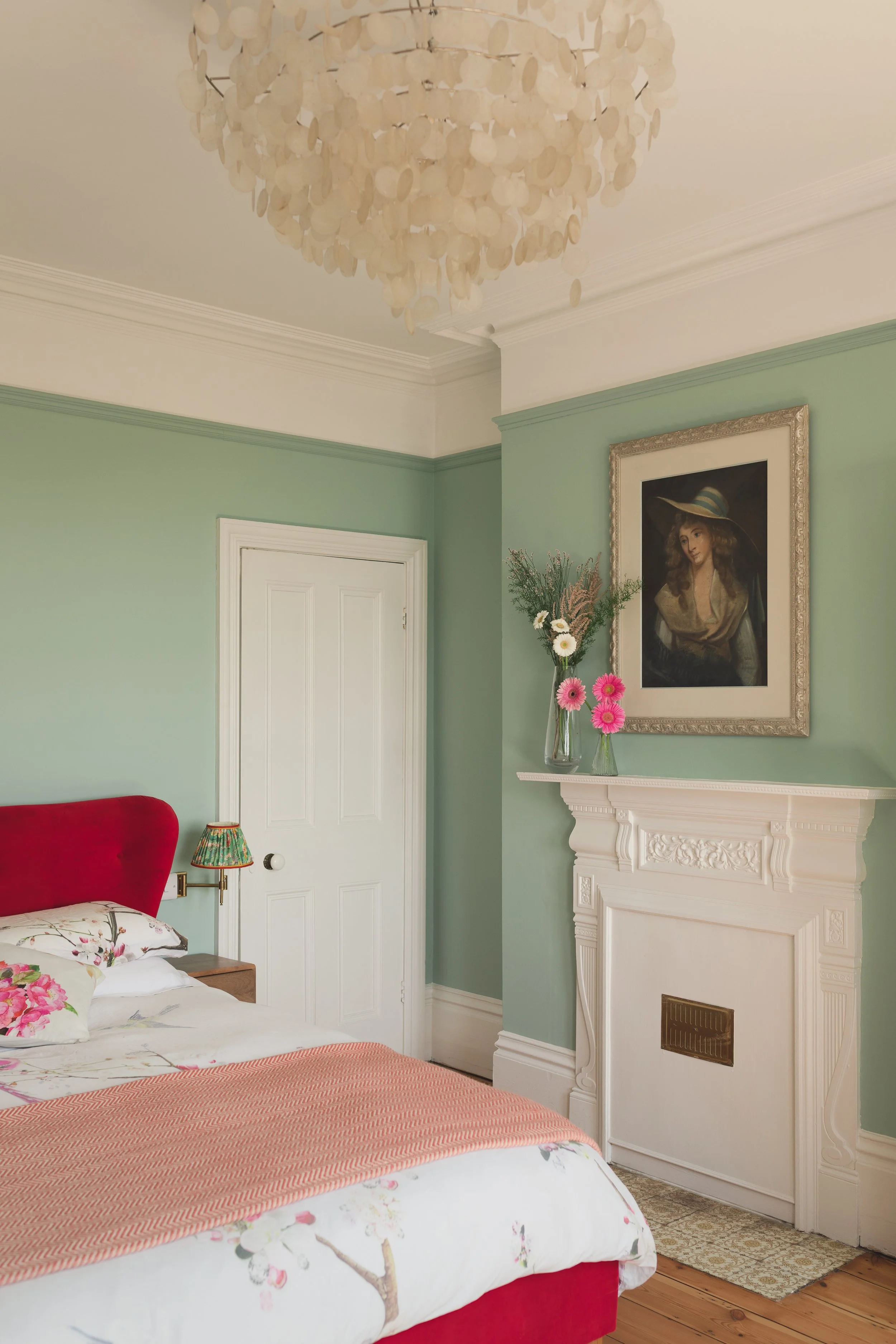 Blue bedroom with fireplace and red velvet bed.jpg
