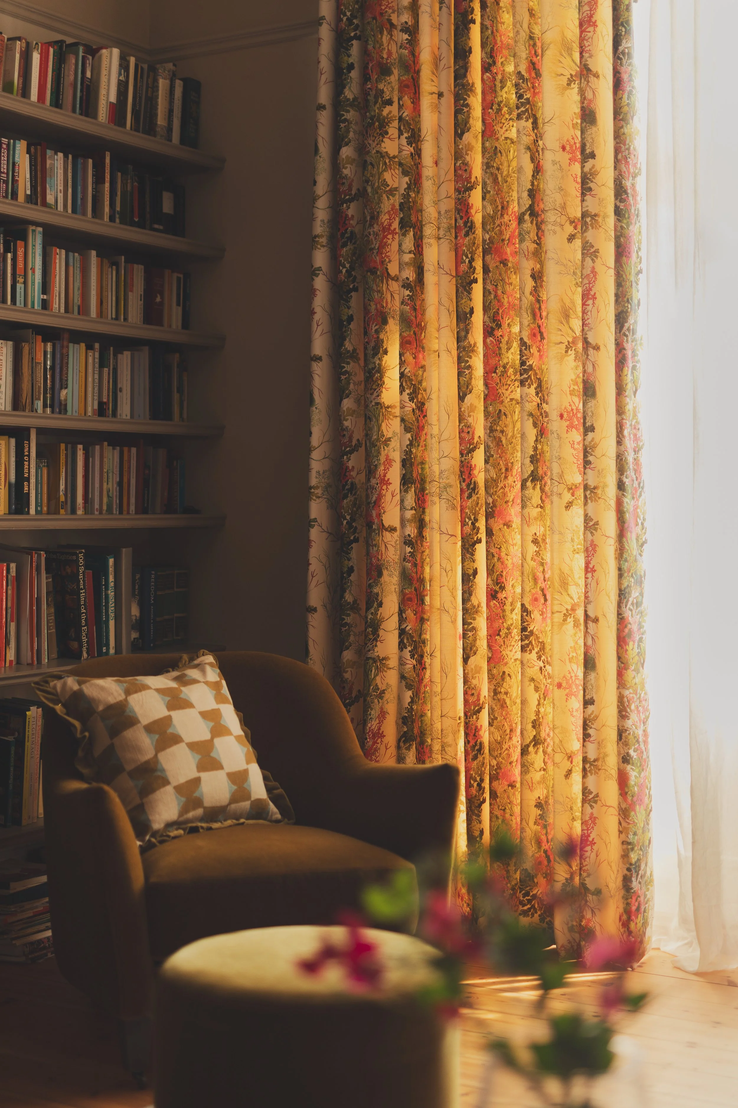 Library with velvet chair and floral curtains.jpg