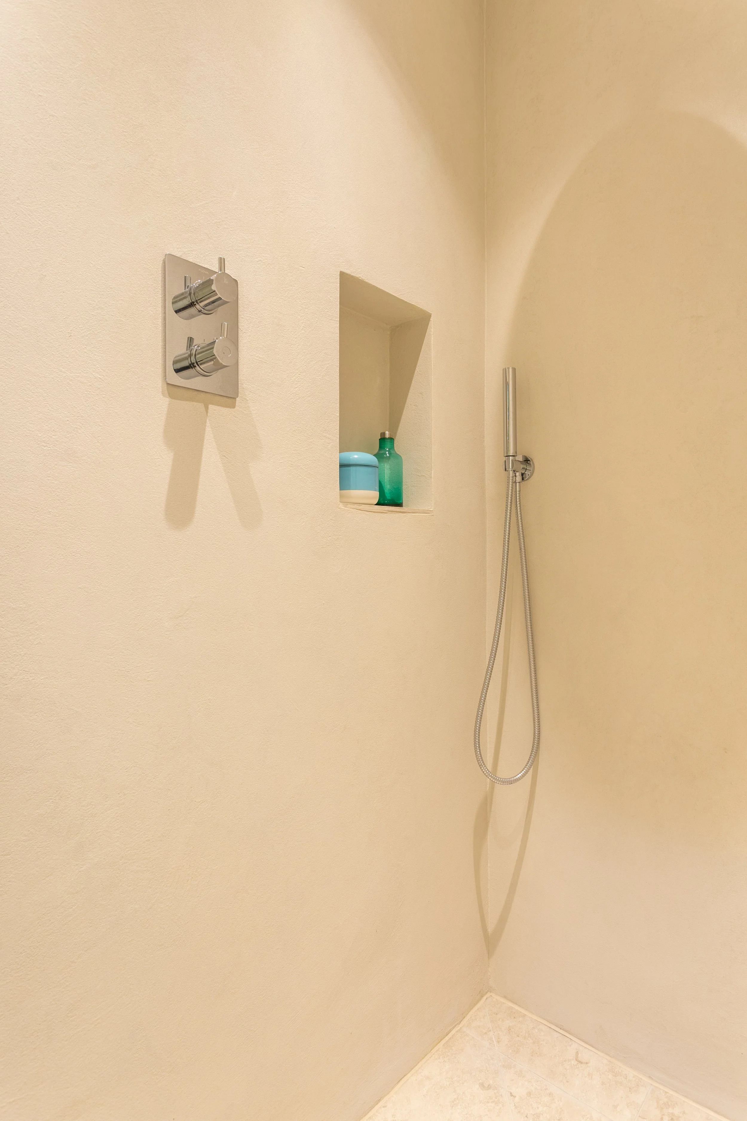 minimal walk in shower with microcement finish.jpg