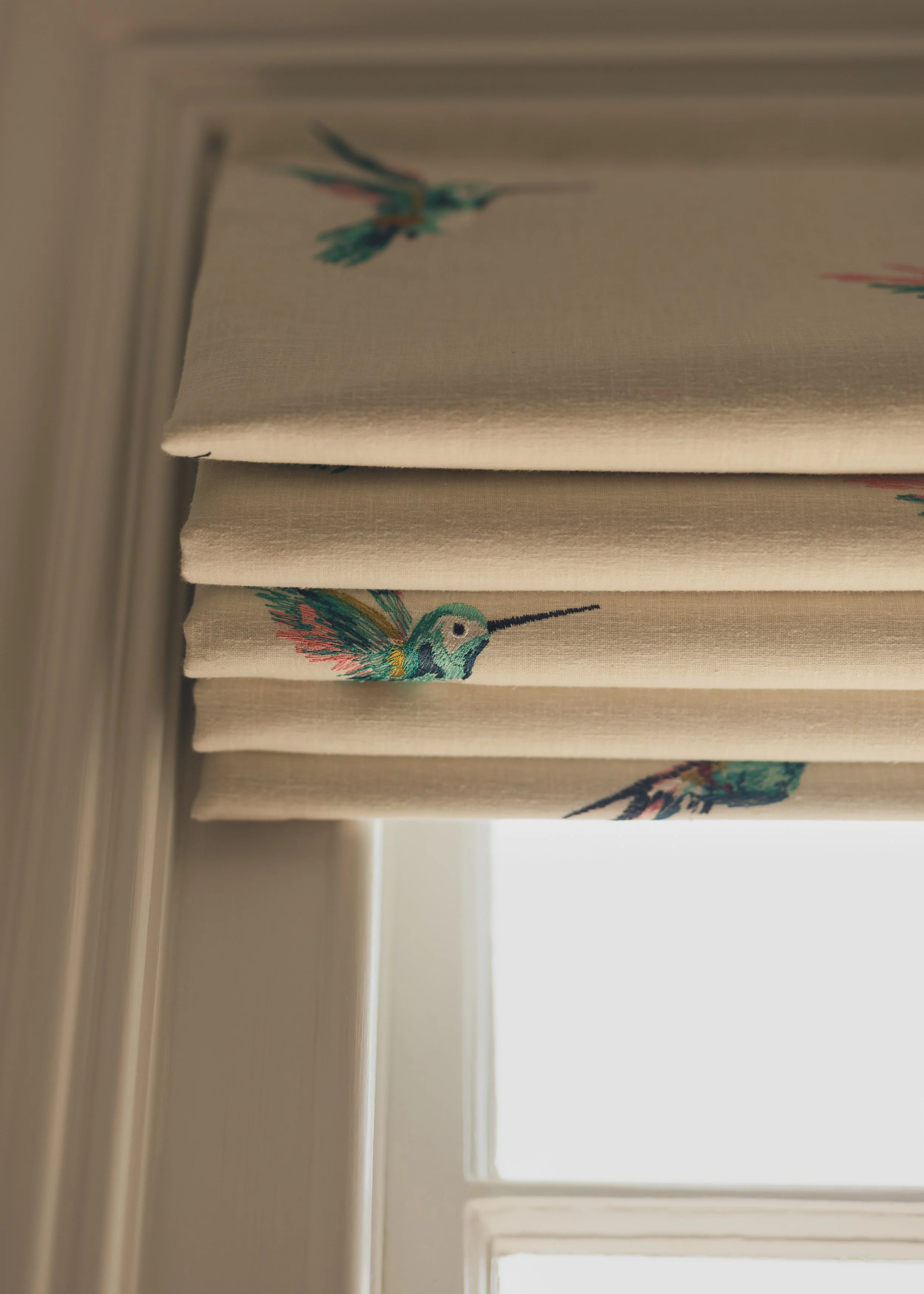 Roman blinds with multi colour birds.jpg