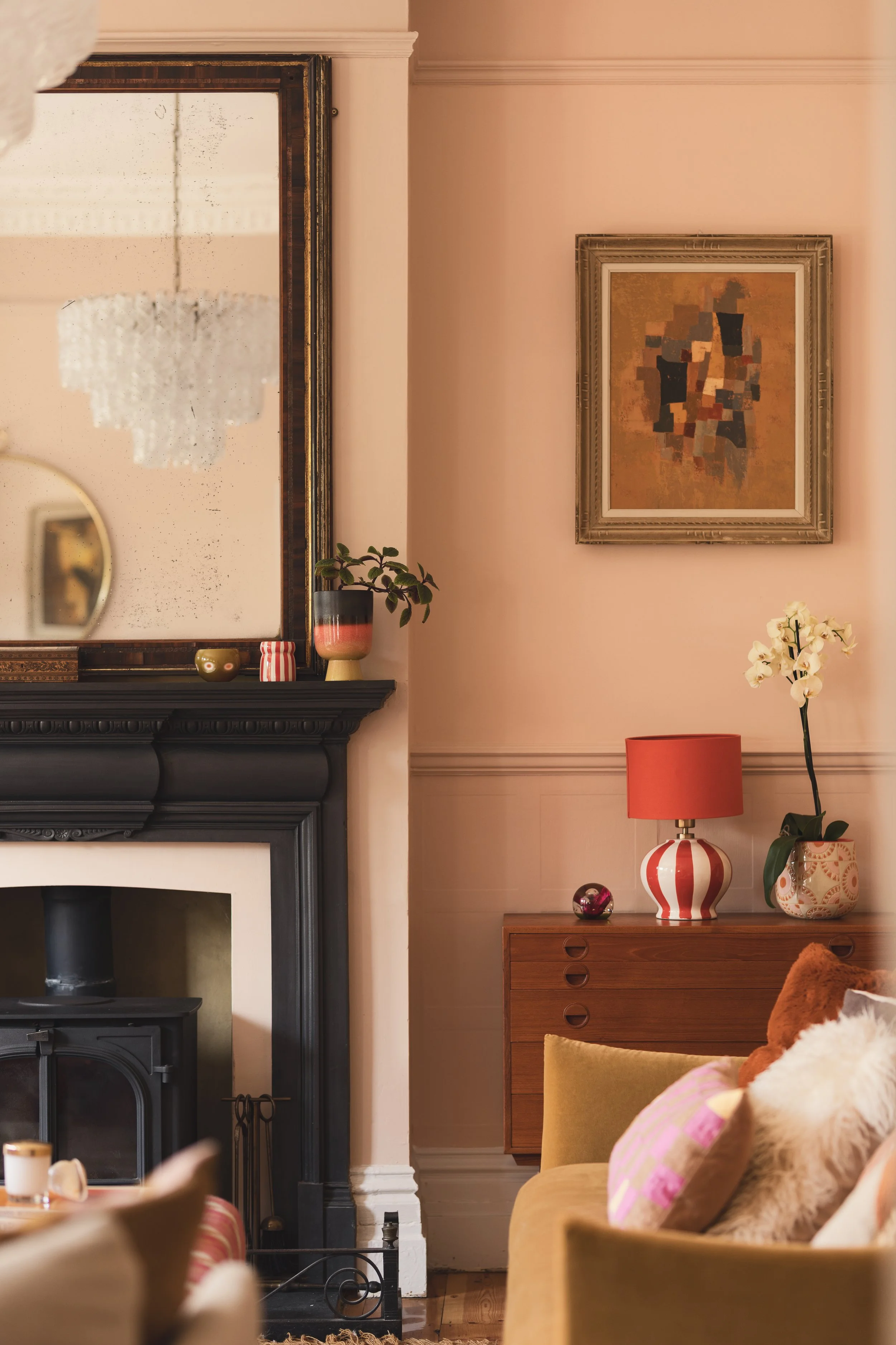 Victorian fireplace with art in pink sitting room.jpg