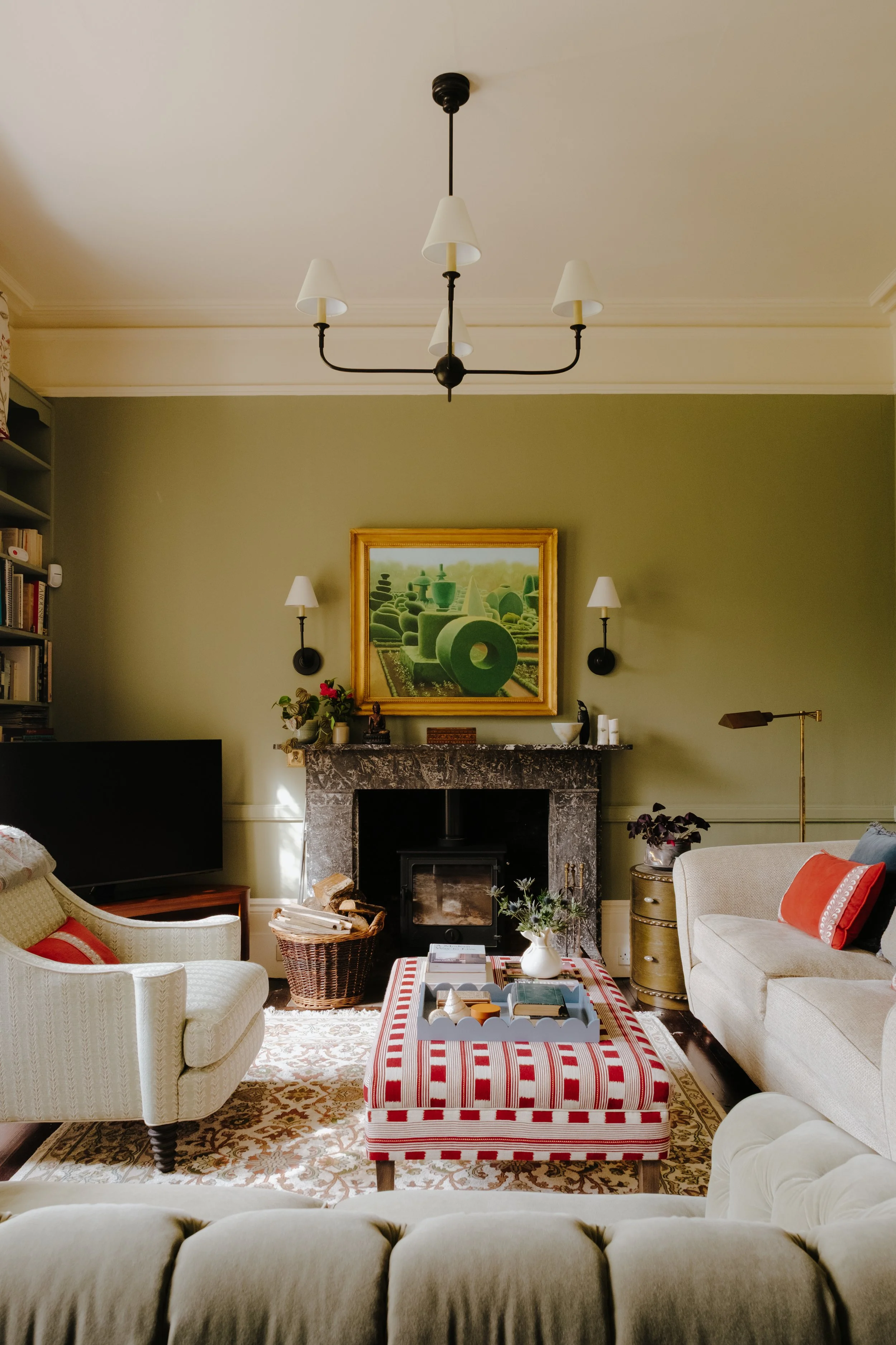 High ceilings, ceiling light, sofas, wall art, pallet of soft pinks and sage