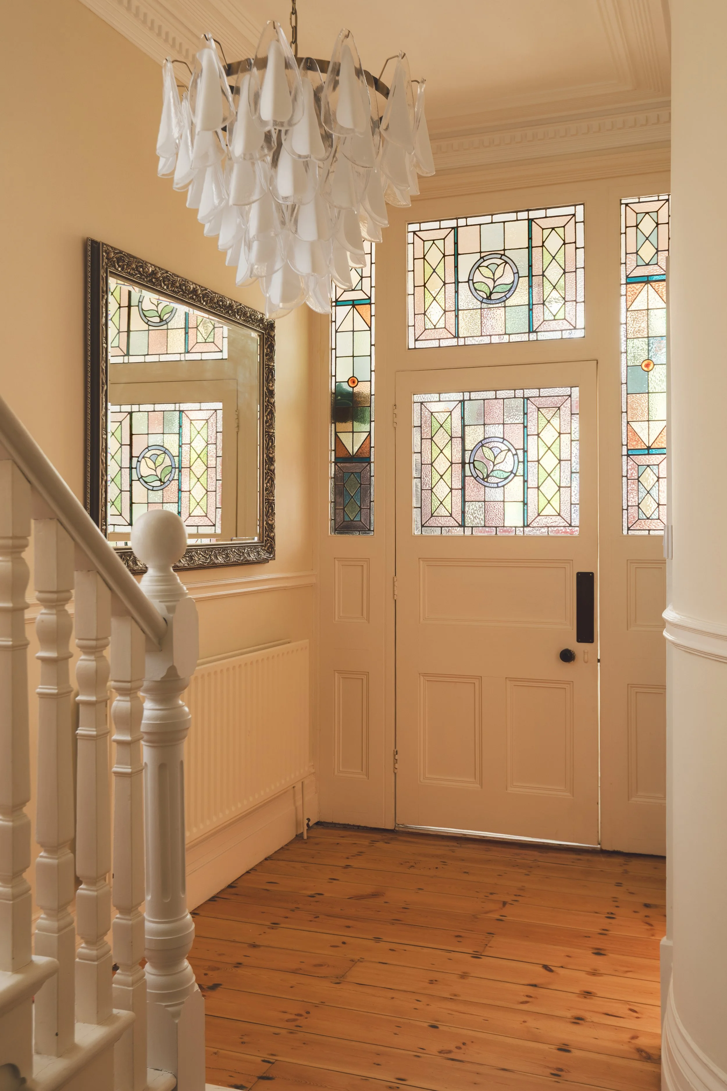 Victorian hall with multi coloured stained glass door.jpg