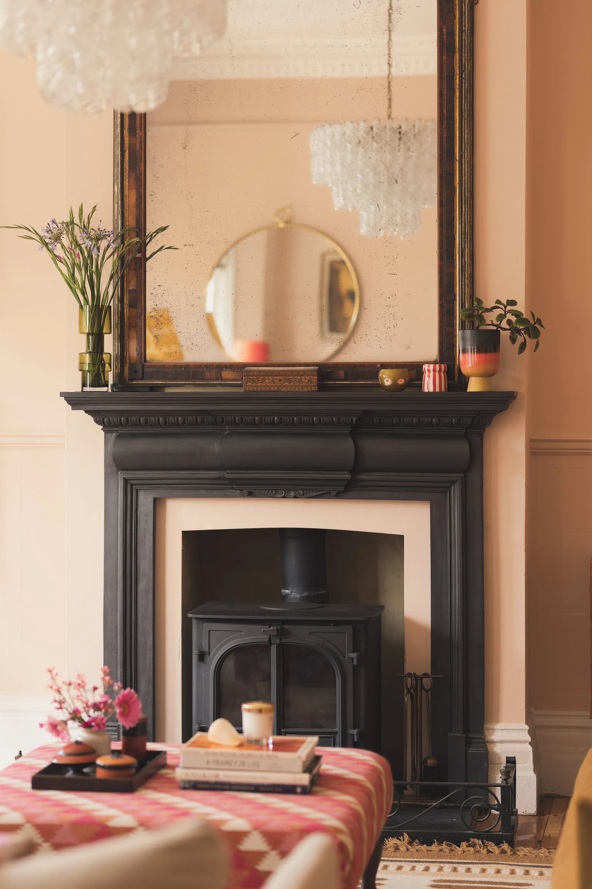 Victorian fireplace with mirror and ottoman.jpg
