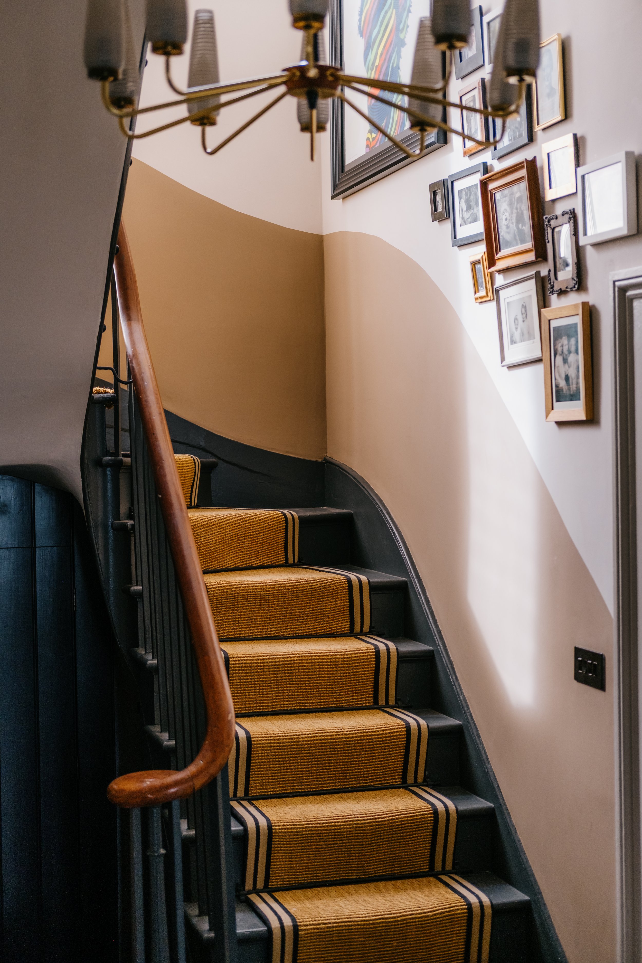 Stairs with art wall and chandelier copy.jpg