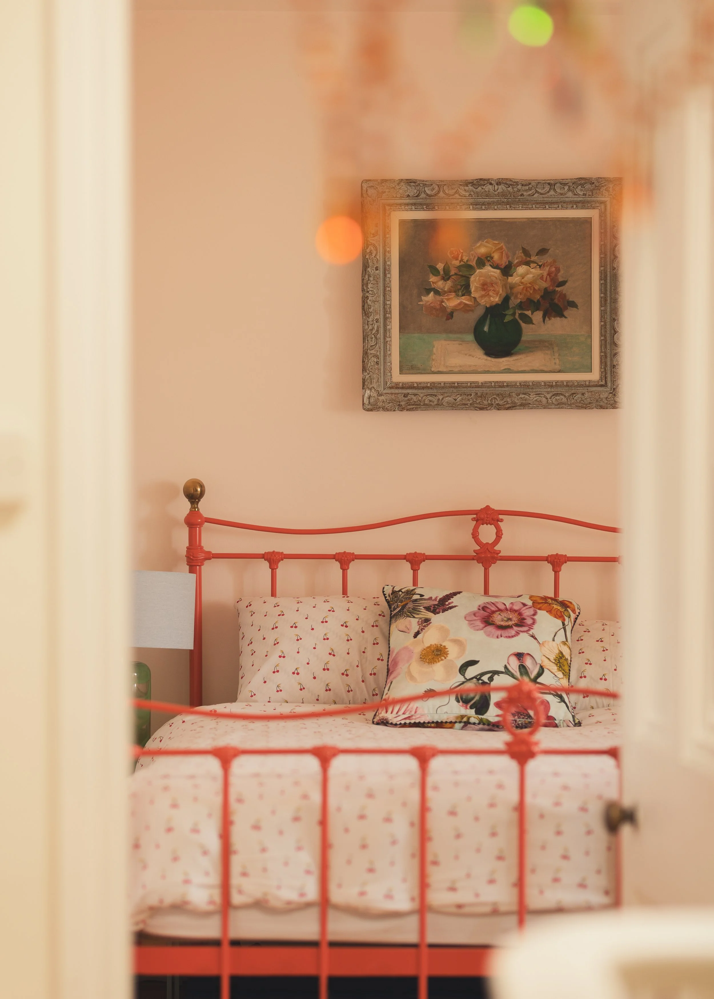Peach bedroom with ornage metal bedstead.jpg