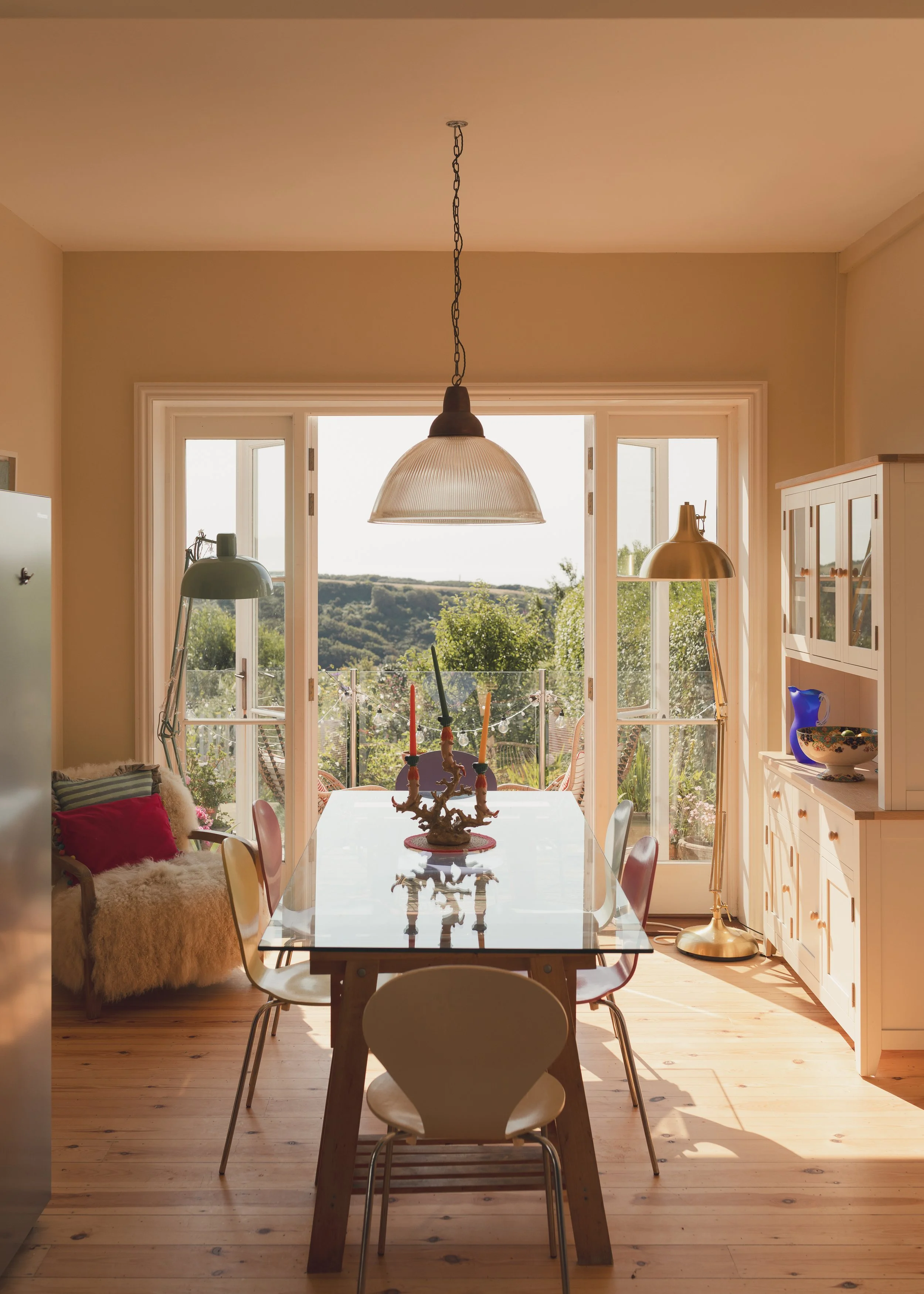 Dining room with glass table and pendant light.jpg