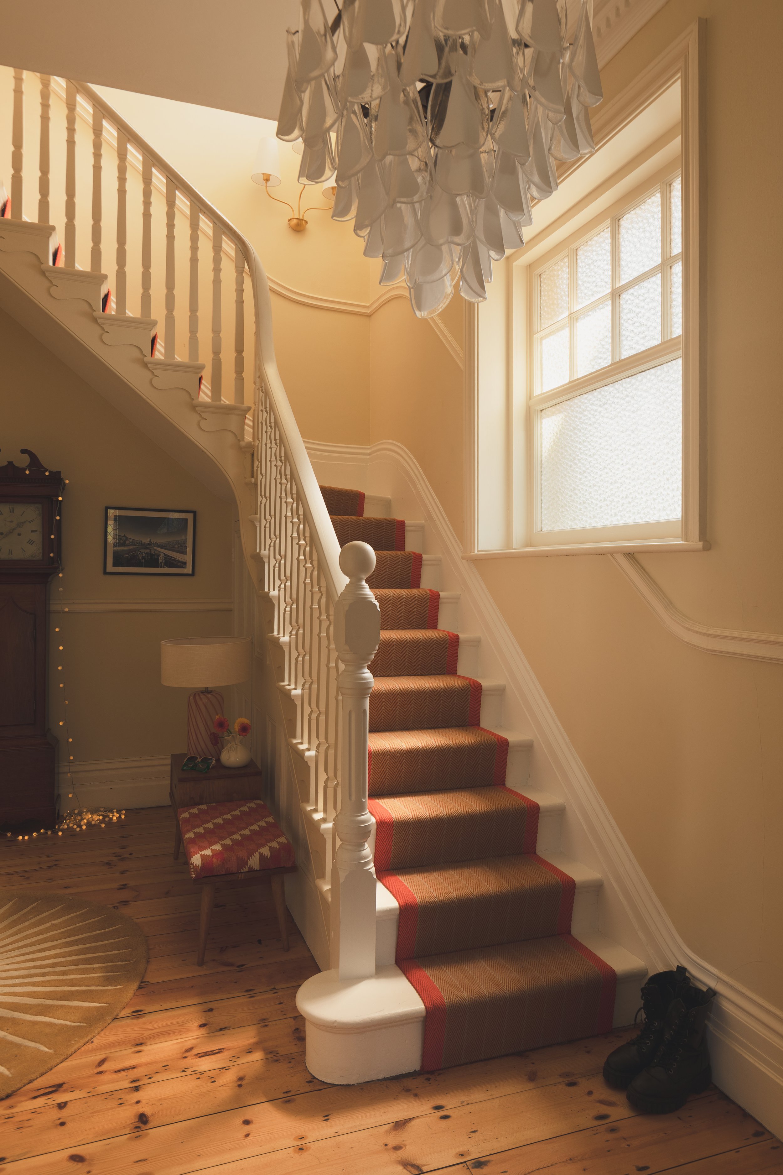 Victorian hallway with staircase and orange runner.jpg