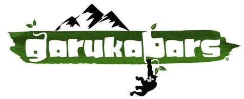 Logo for Garuka Bars featuring a mountain range and a person hanging from a vine.