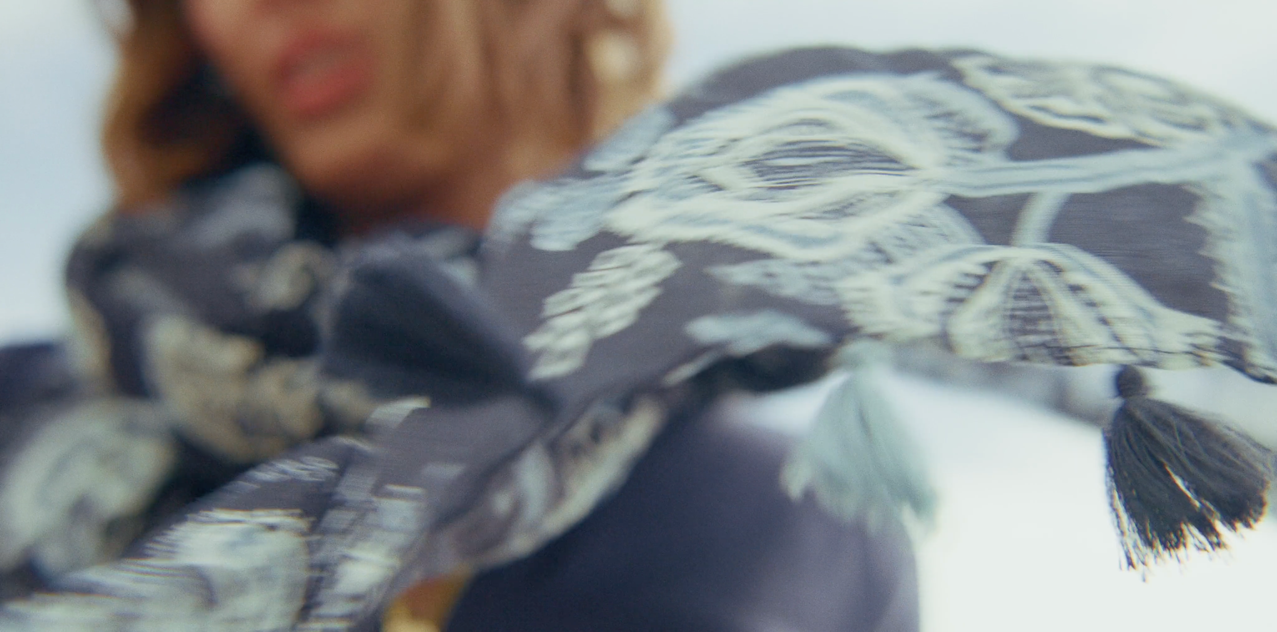 Beau Kester Director and Director of Photography capturing model Bella Davison at Oyster Factory in coastal South Carolina, cinematic fashion storytelClose-up of a woman wearing a patterned scar