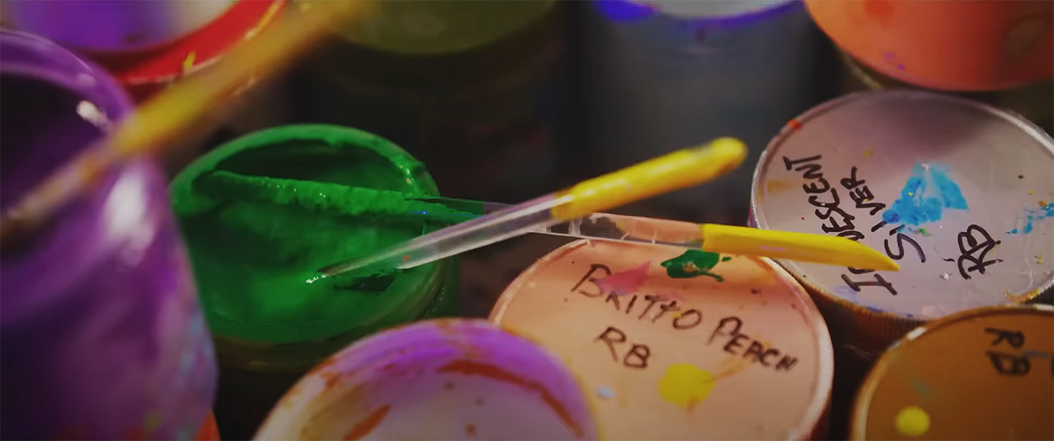 Beau Kester Director and Director of Photography capturing still from The Britto Doc documentary about Romero Britto’s artistic journey from Brazil to global influence in vibrant pop art storytelling. Close-up of Romero Britto's c paint in his studio