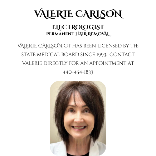 Smiling woman with shoulder-length dark hair, wearing a white blazer, against a plain background.