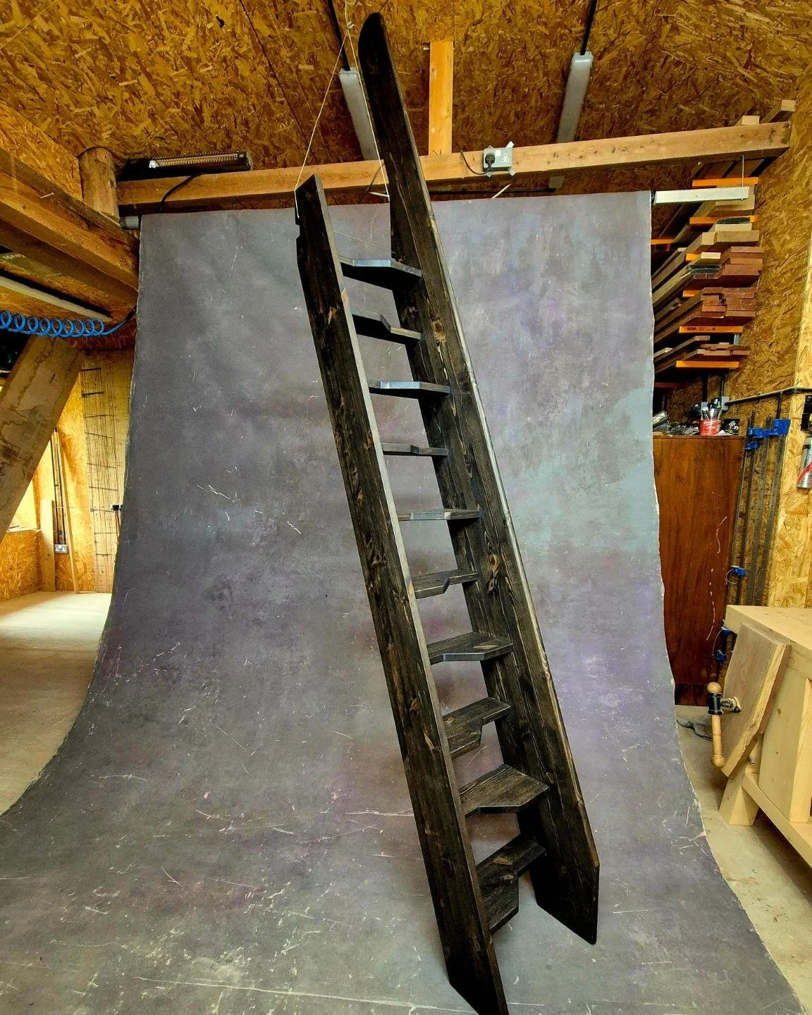 A dramatic space-saving stairs... zoom in!
A "hit and miss" staircase has alternating left and right steps that serve a very important purpose. 
Overlapping asymmetrical treads like this dramatically reduces the overall size of the stairc