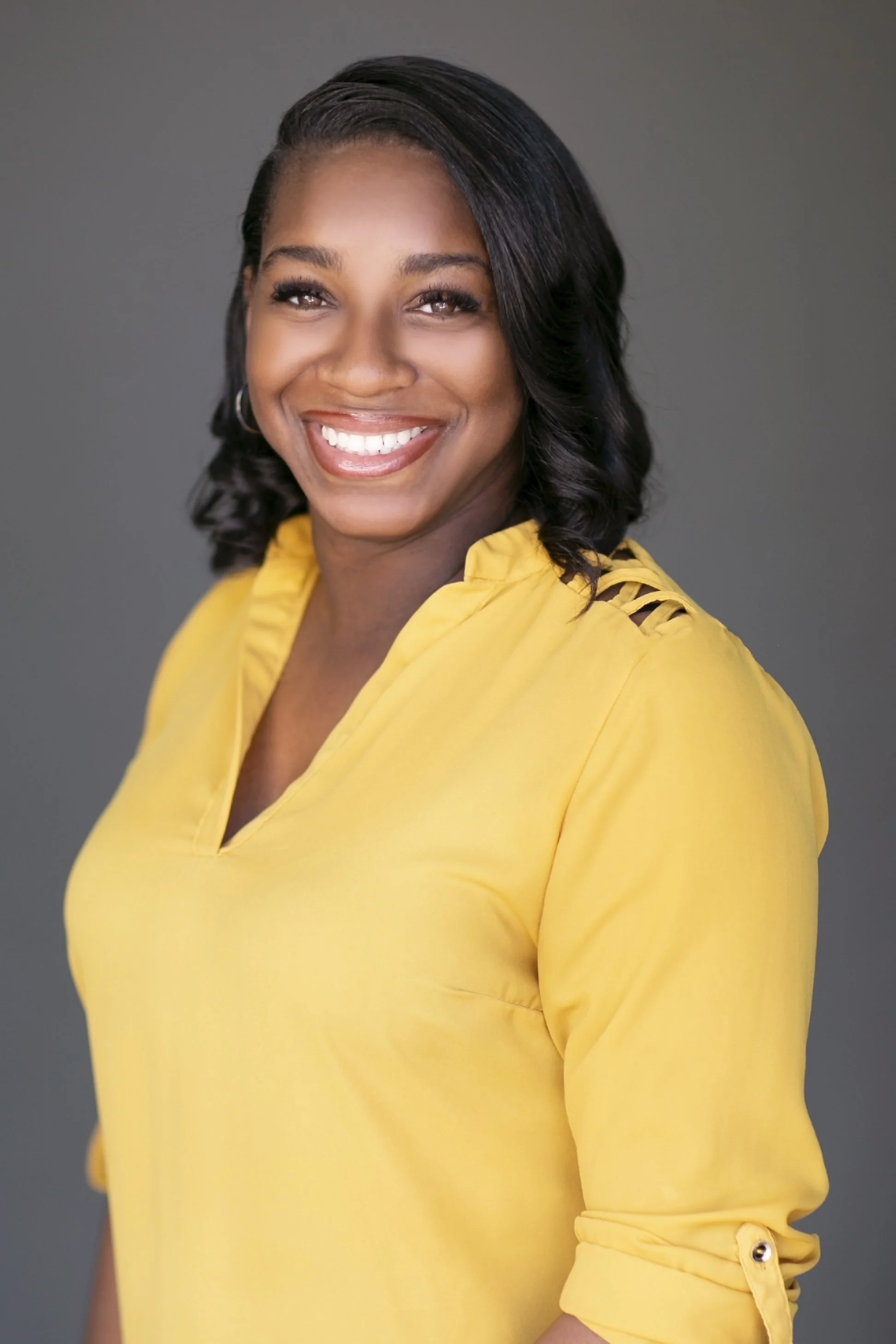 Headshot of Krystal Burton in a yellow top