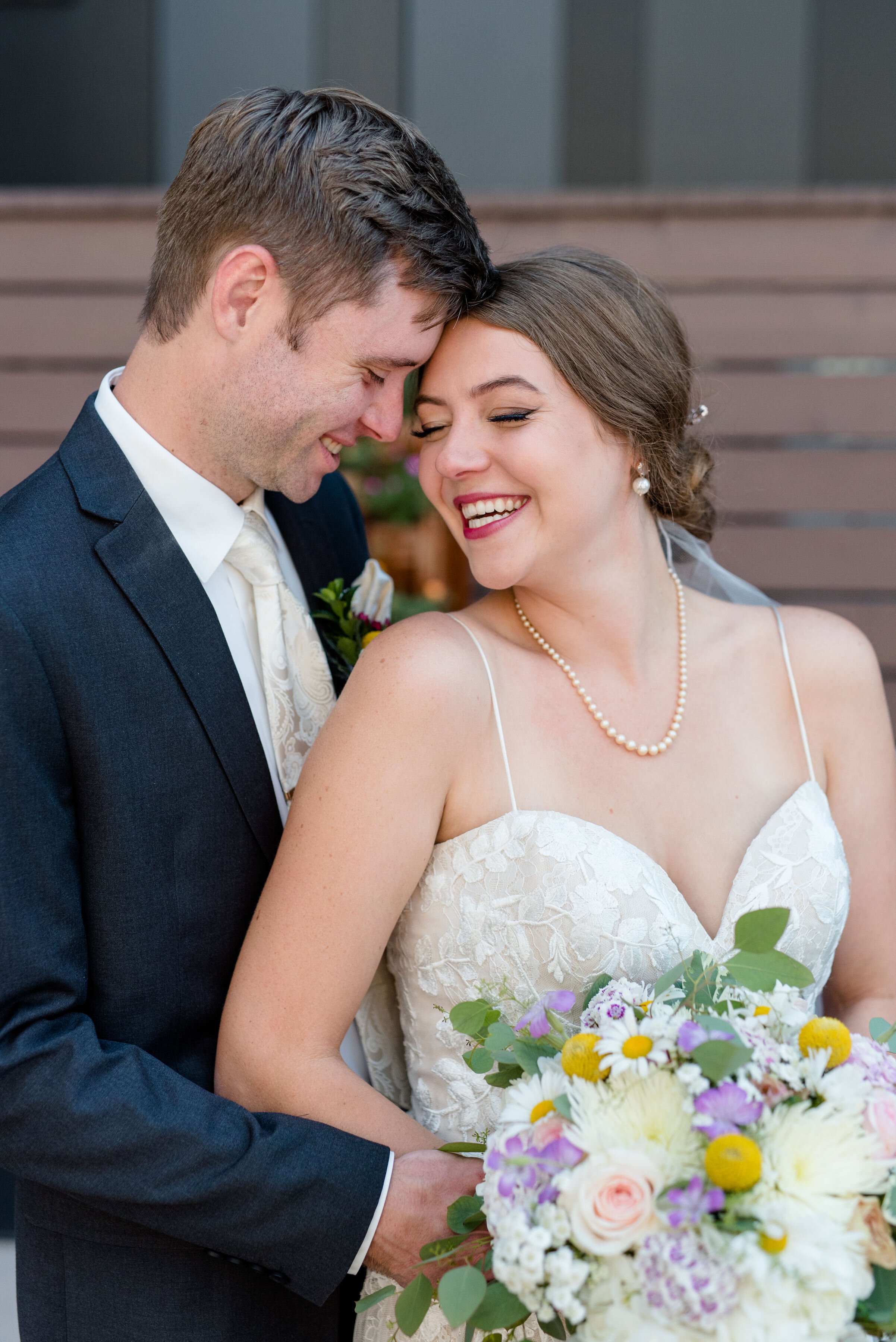 BrideAndGroomSnuggleTogetherLismoreHotelRooftop.jpeg