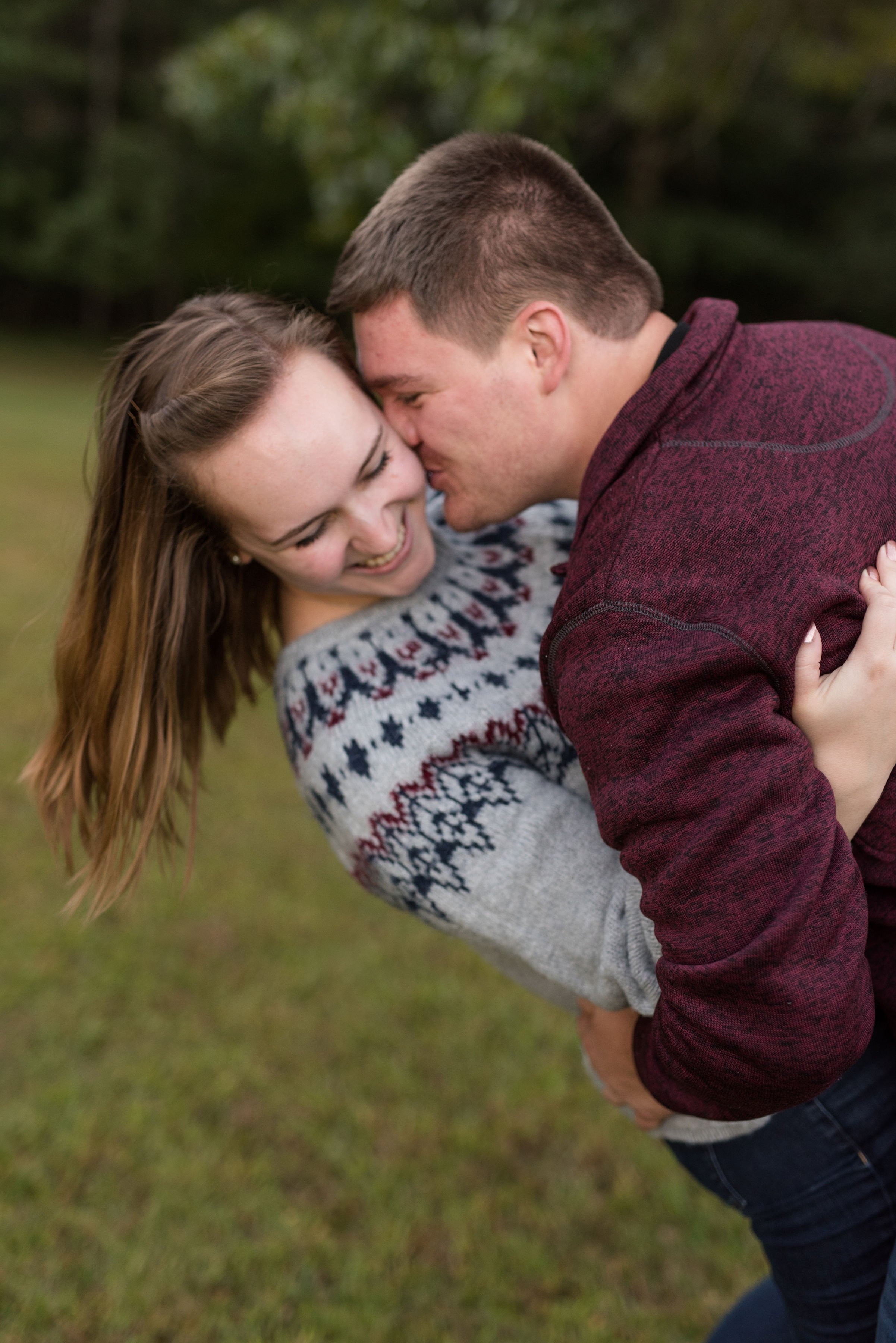 Engaged Couple Plays Together in the Fall Weather.jpeg